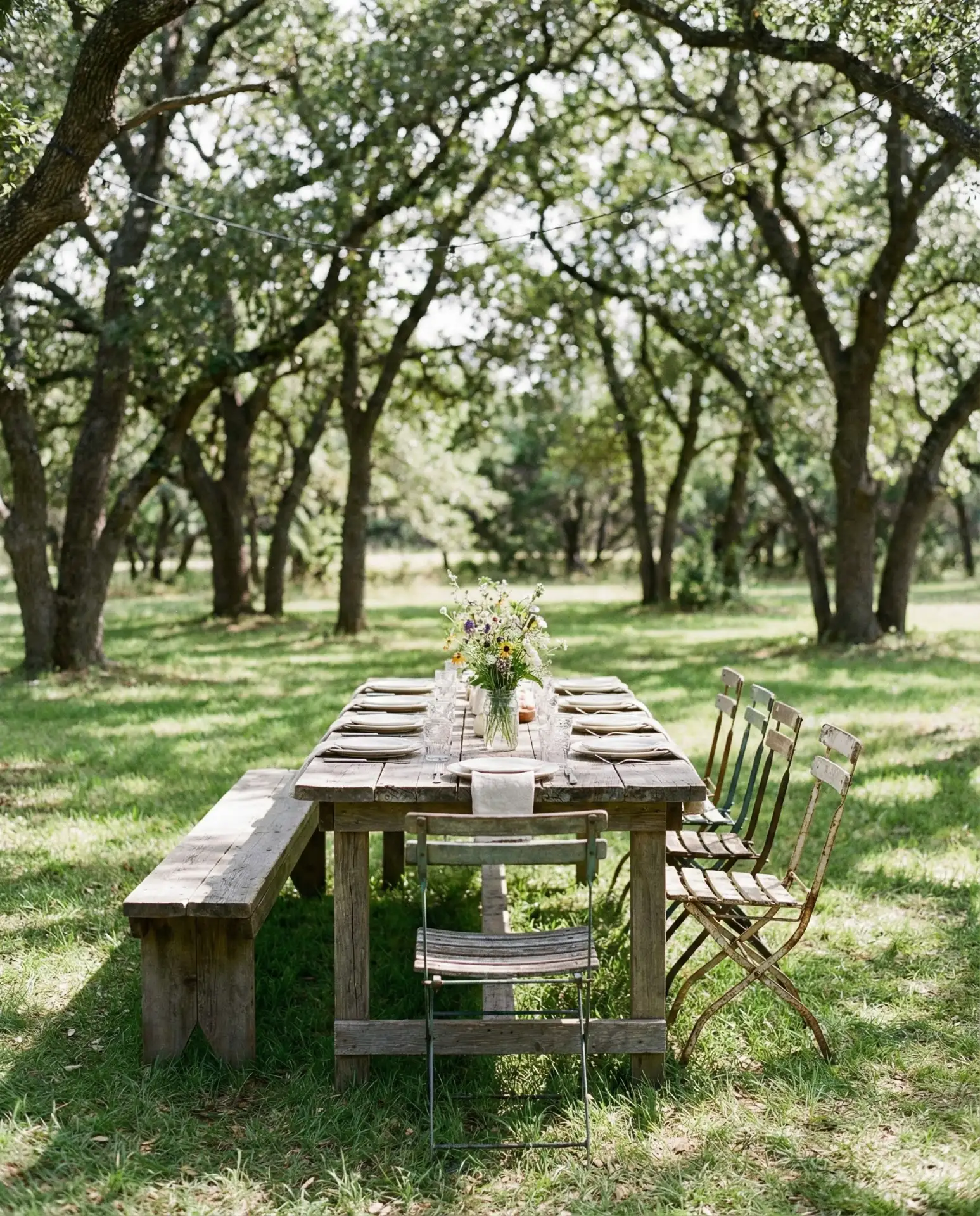 Rustic Farmhouse Table Under Oak Trees 1