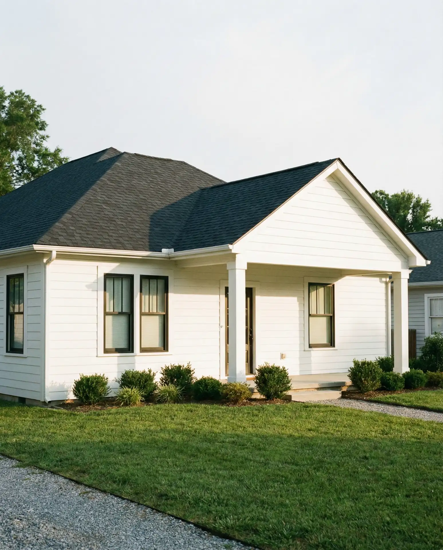 White Bungalow with Dark Roof Contrast