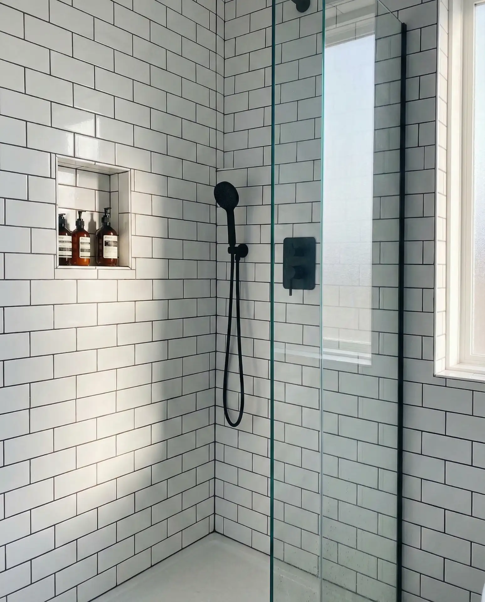 Black Matte Fixtures Against White Subway Tile 1