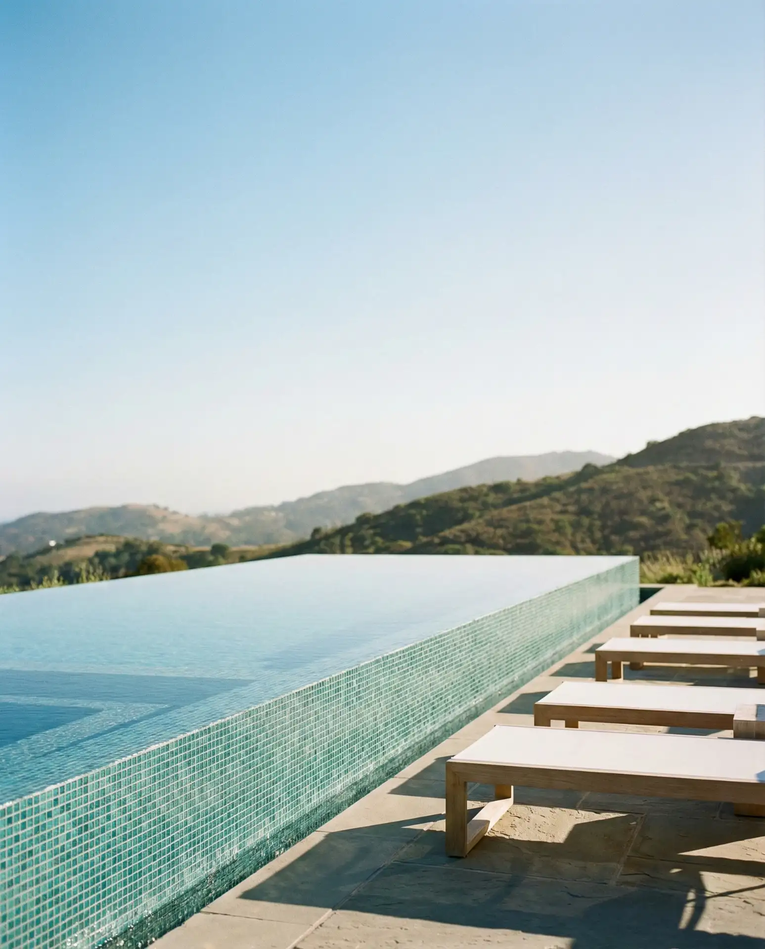Sleek Infinity Pool with Glass Tile Mosaic 1