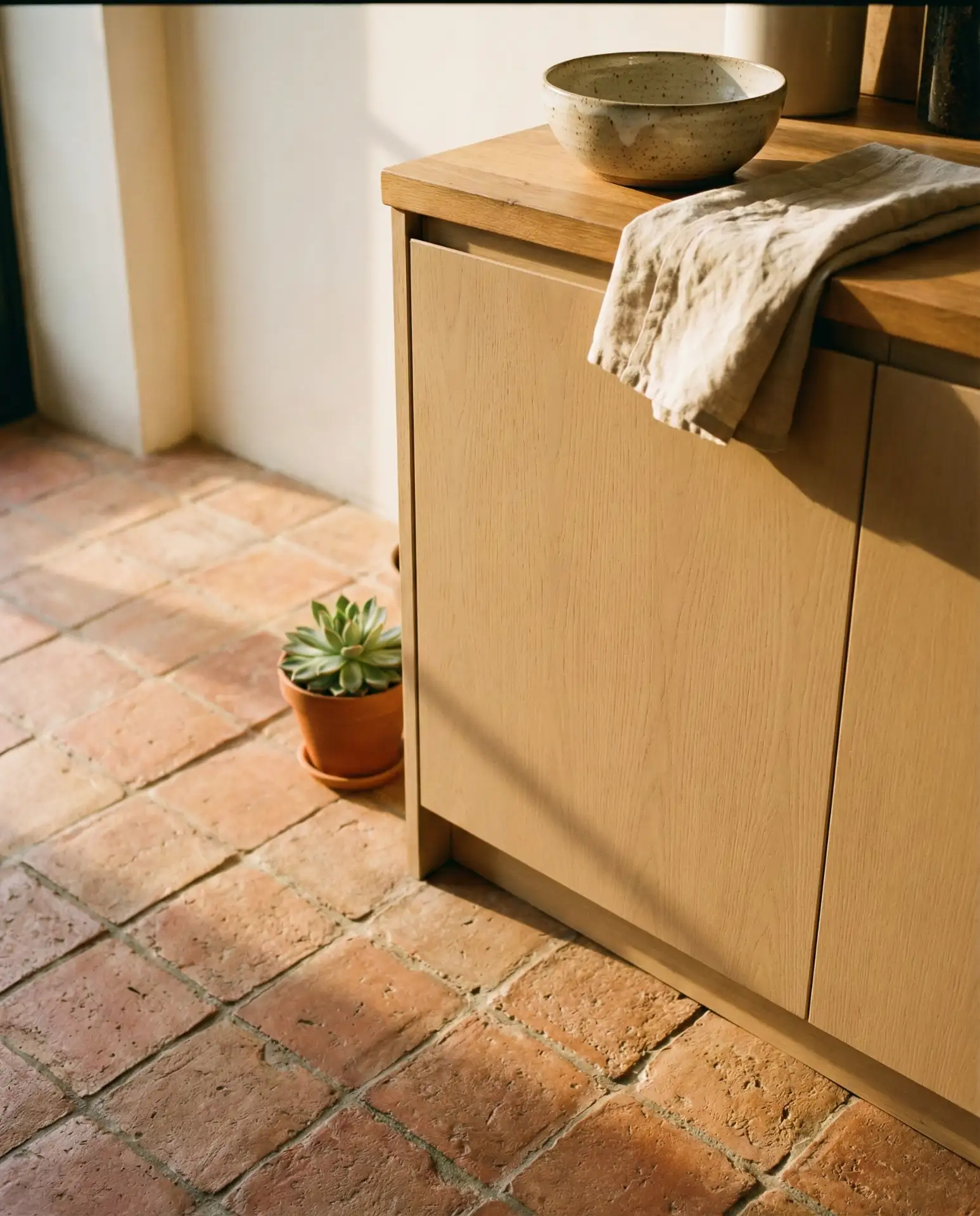 Warm Beige Cabinets with Terracotta Tile Floor 1