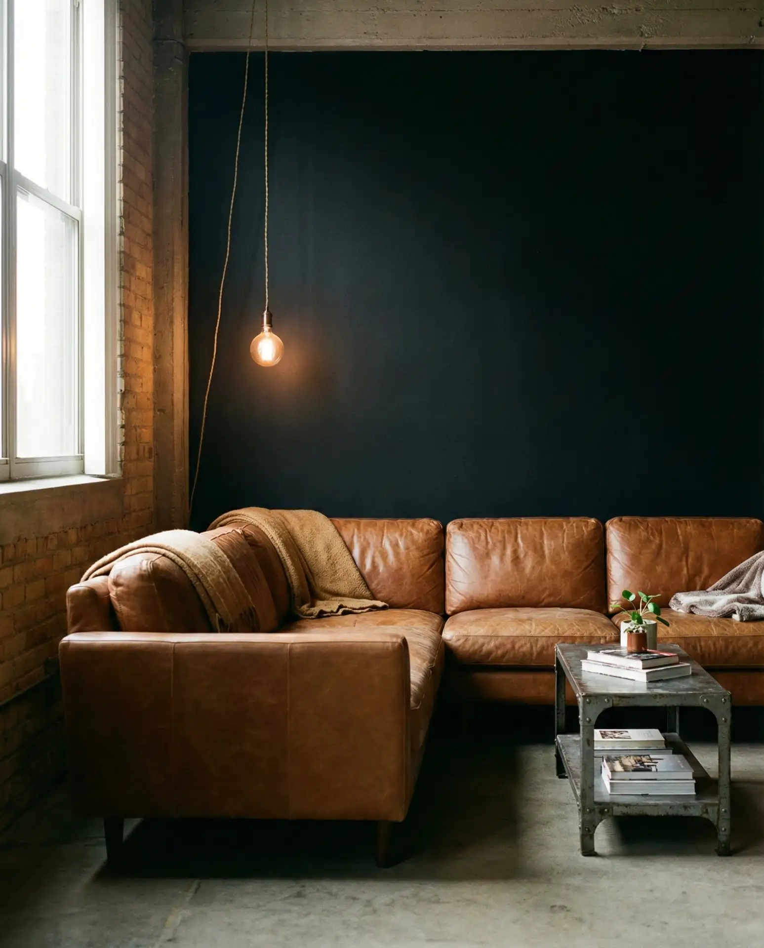 Black Accent Wall Behind Brown Leather Couch 1