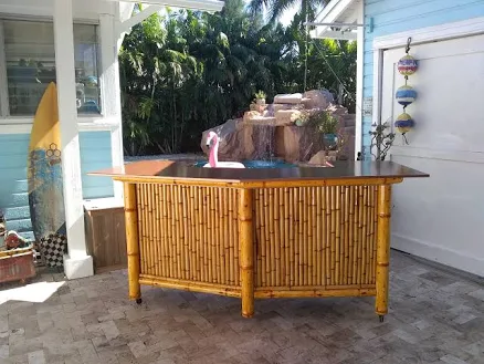 Bamboo tiki bar with storage cabinets, electrical outlets, Led lights, and drink