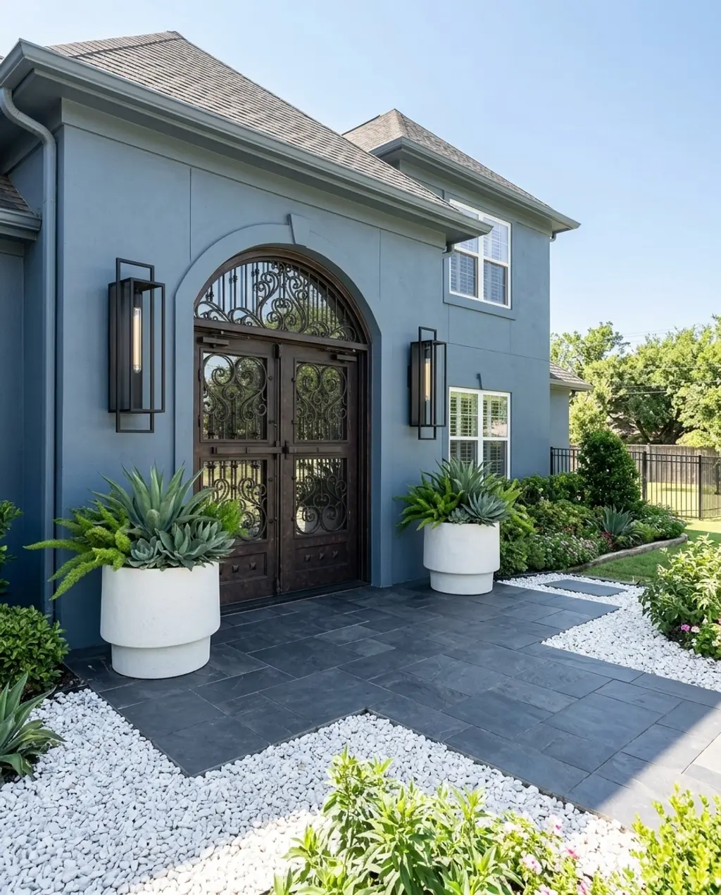 Grand Entrance with Oversized Black Pavers and White Gravel Contrast