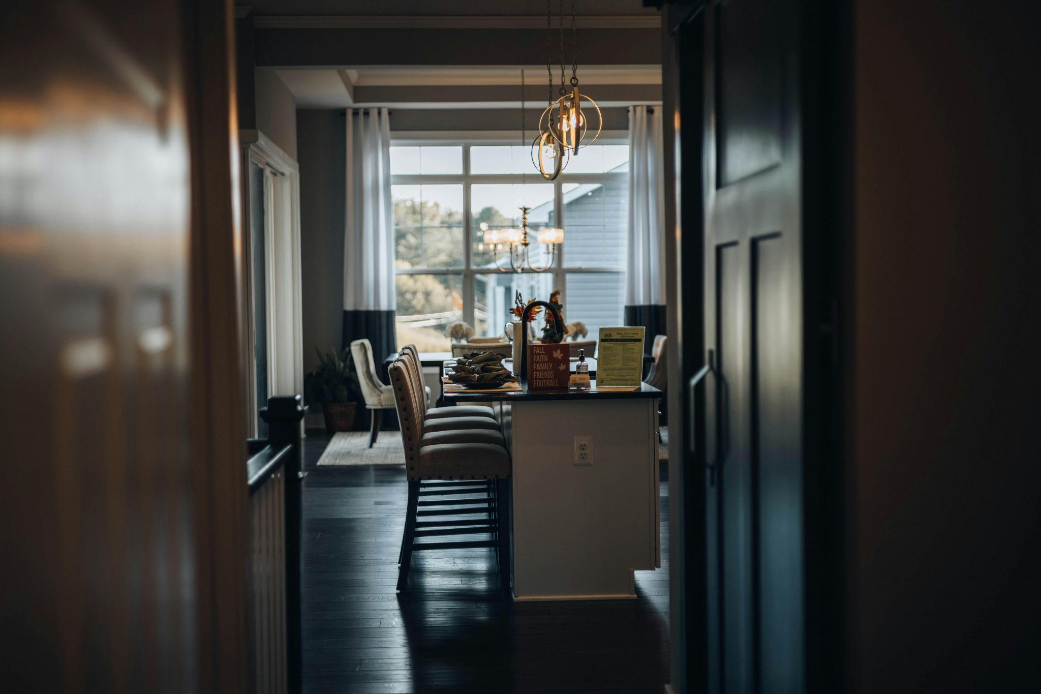 A beautifully designed kitchen with elegant seating and artistic lighting, showcasing luxury and style.