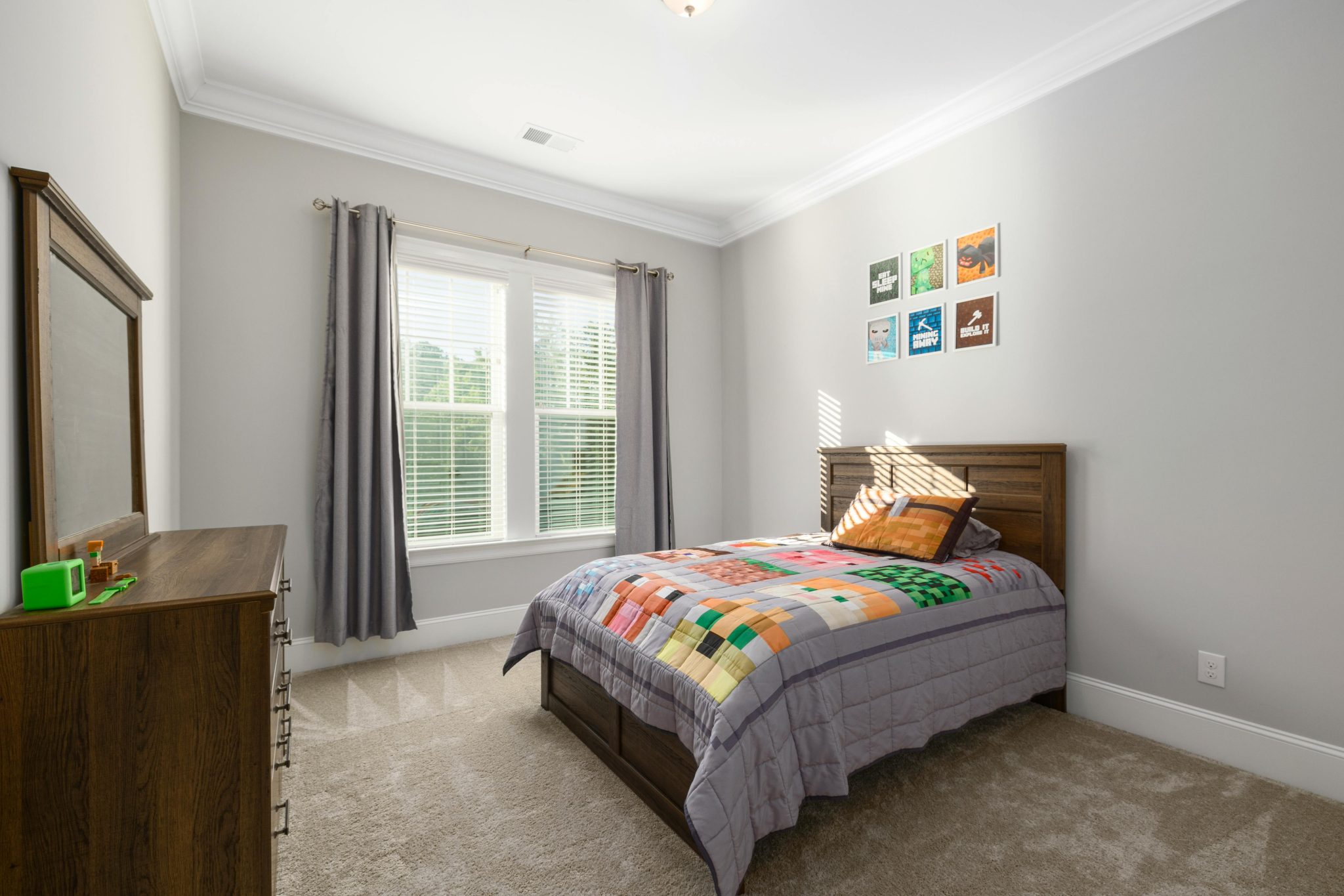 A bright and cozy bedroom with a colorful bedspread, perfect for modern interior design inspiration.