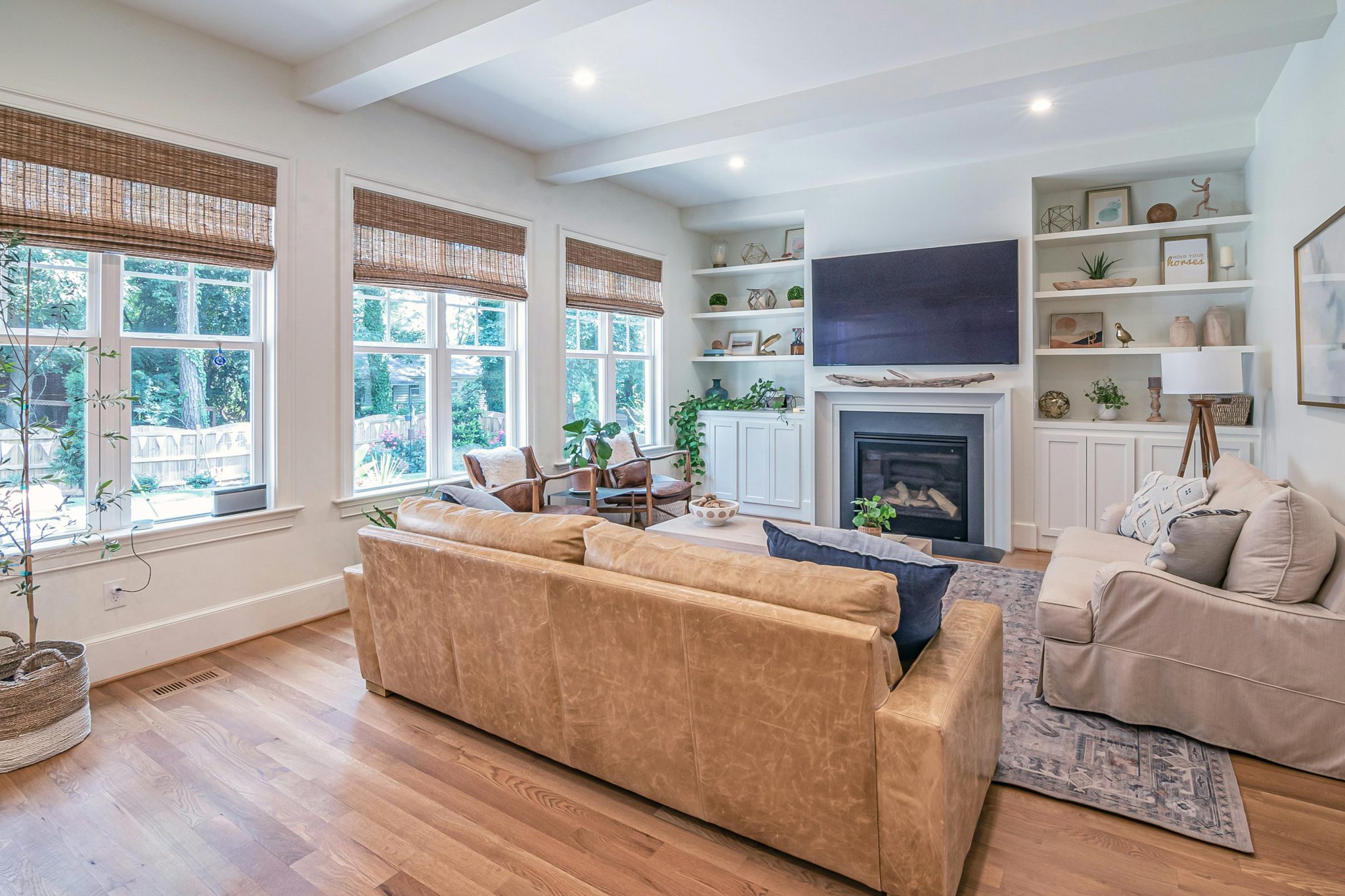 A bright and cozy modern living room featuring a fireplace and stylish interior design.