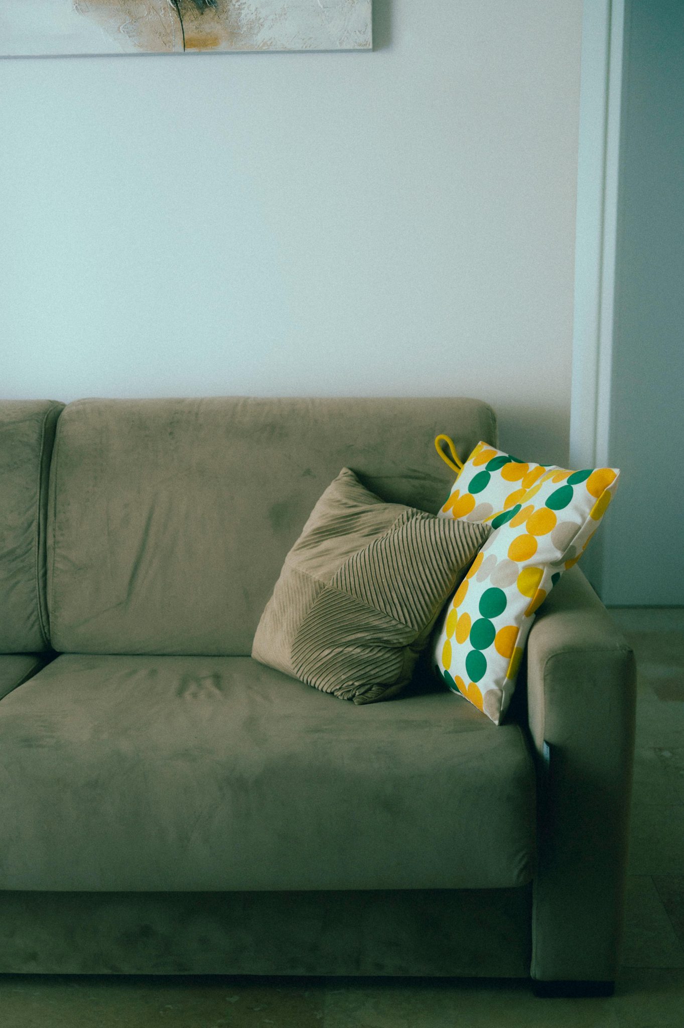 A comfortable beige sofa with patterned cushions enhances a modern living room.