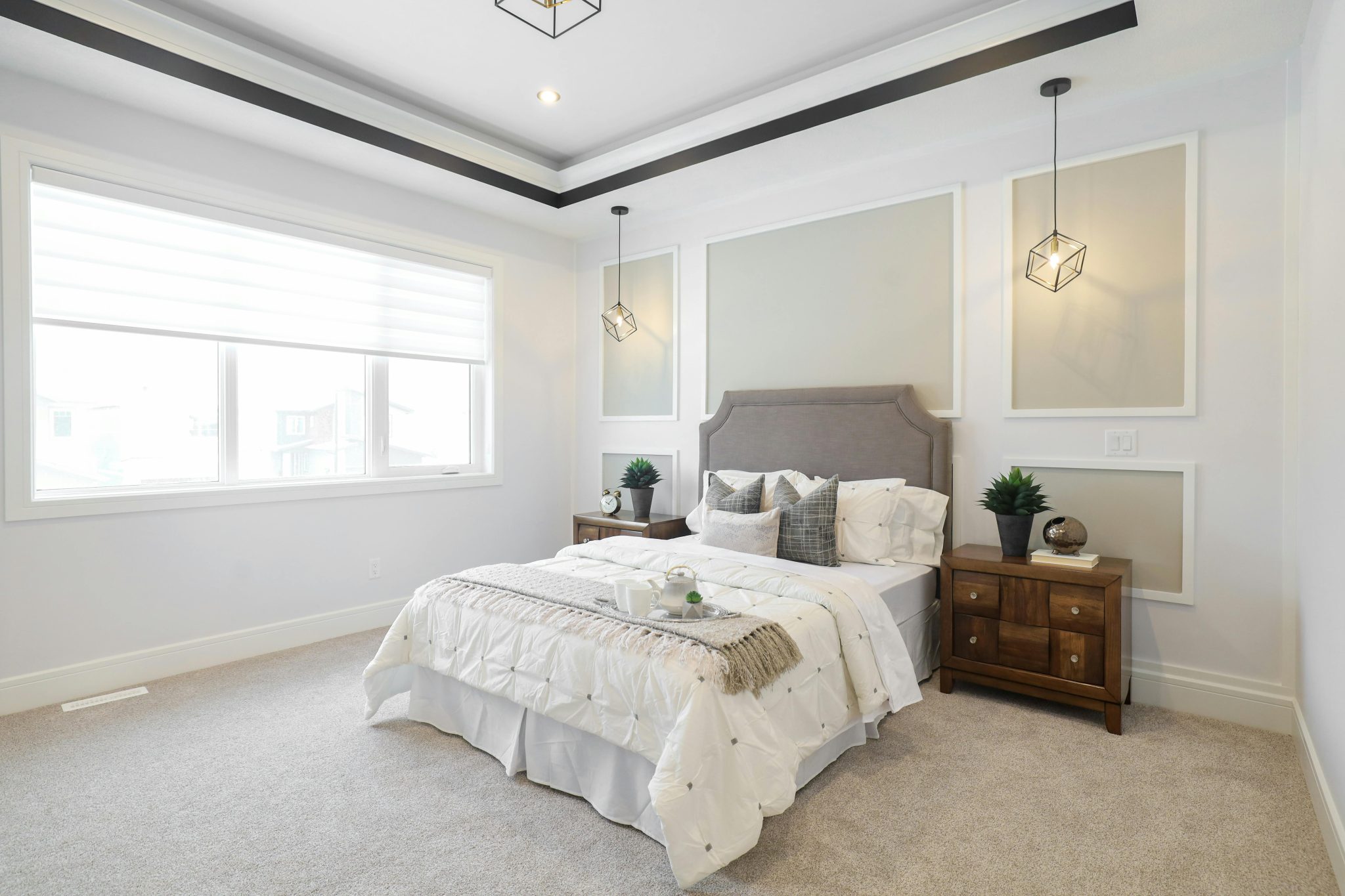 A contemporary bedroom in Edmonton, featuring stylish lighting and minimalist decor.