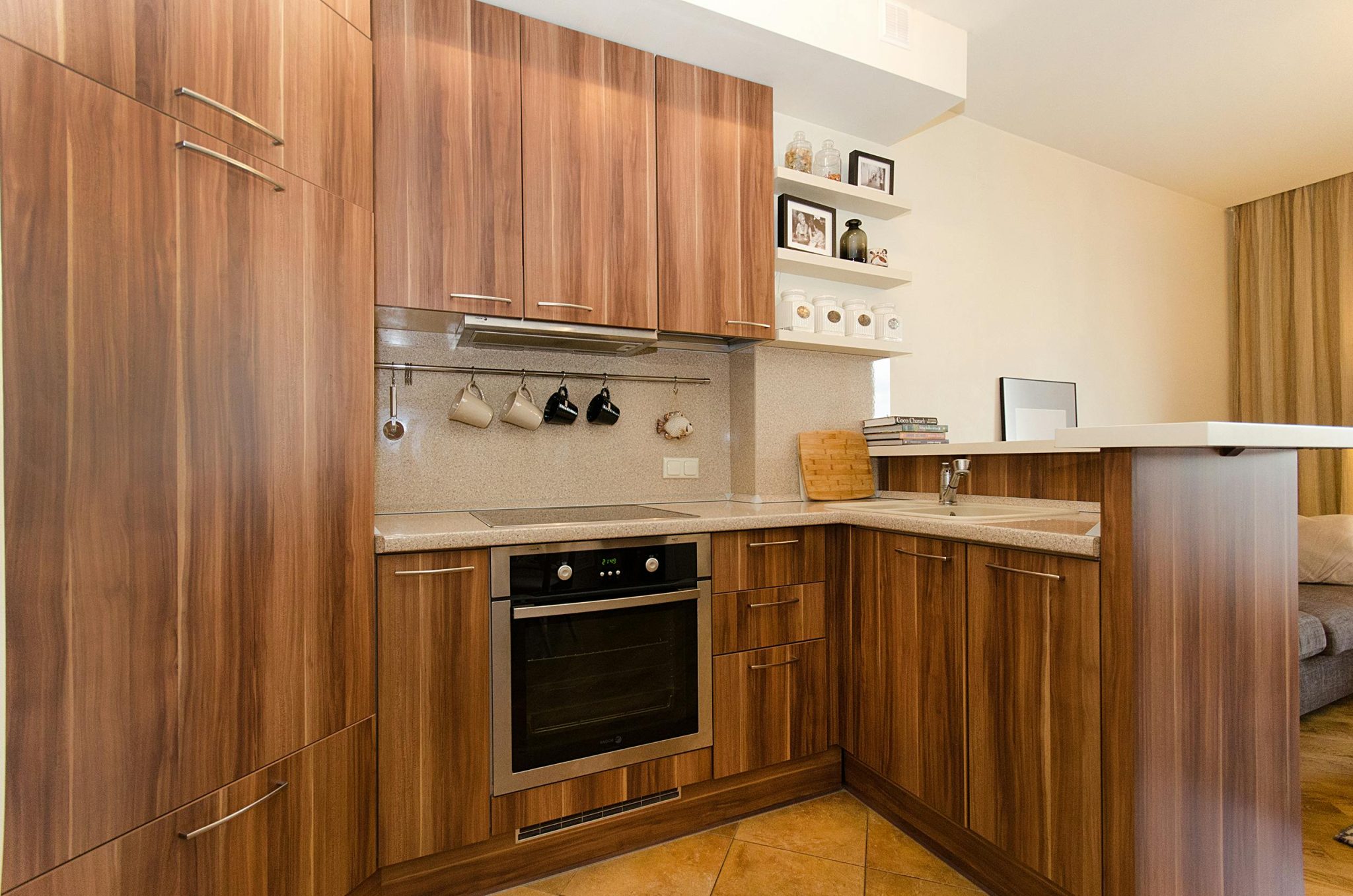 A contemporary kitchen design showcasing wooden cabinets, open shelves, and stainless steel appliances.