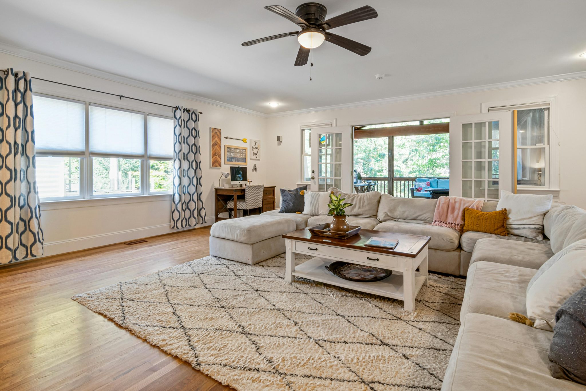 A cozy living room with modern decor, large windows, and ample natural light.