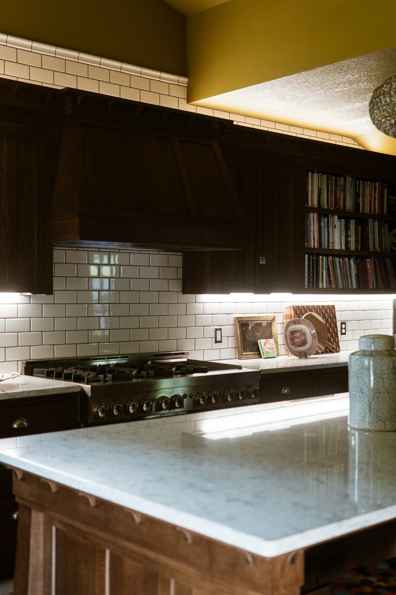 A kitchen with a stove top oven and a sink