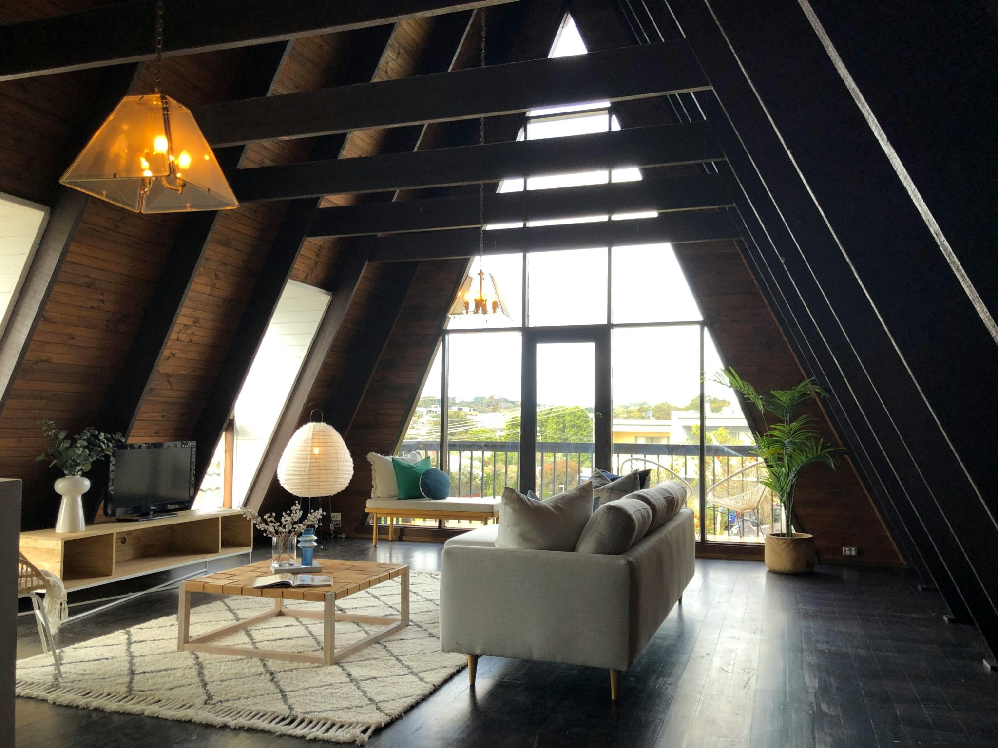 A stylish and cozy attic living room with modern furniture and warm lighting.