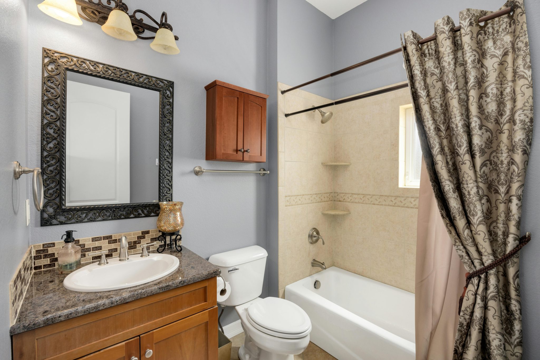 A stylish bathroom featuring modern amenities with classic design elements, perfect for home interiors.