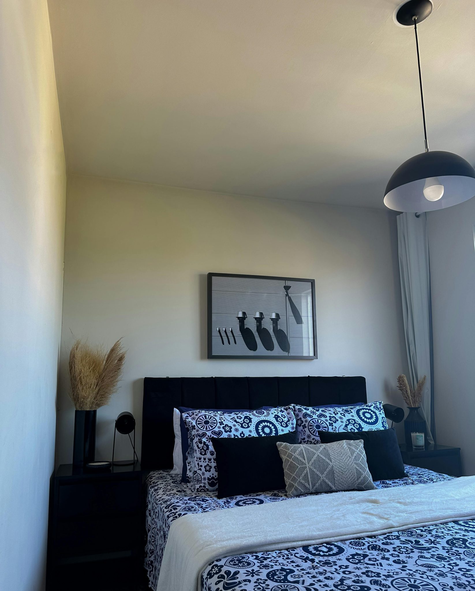 A stylish modern bedroom featuring black and white decor with elegant accents.