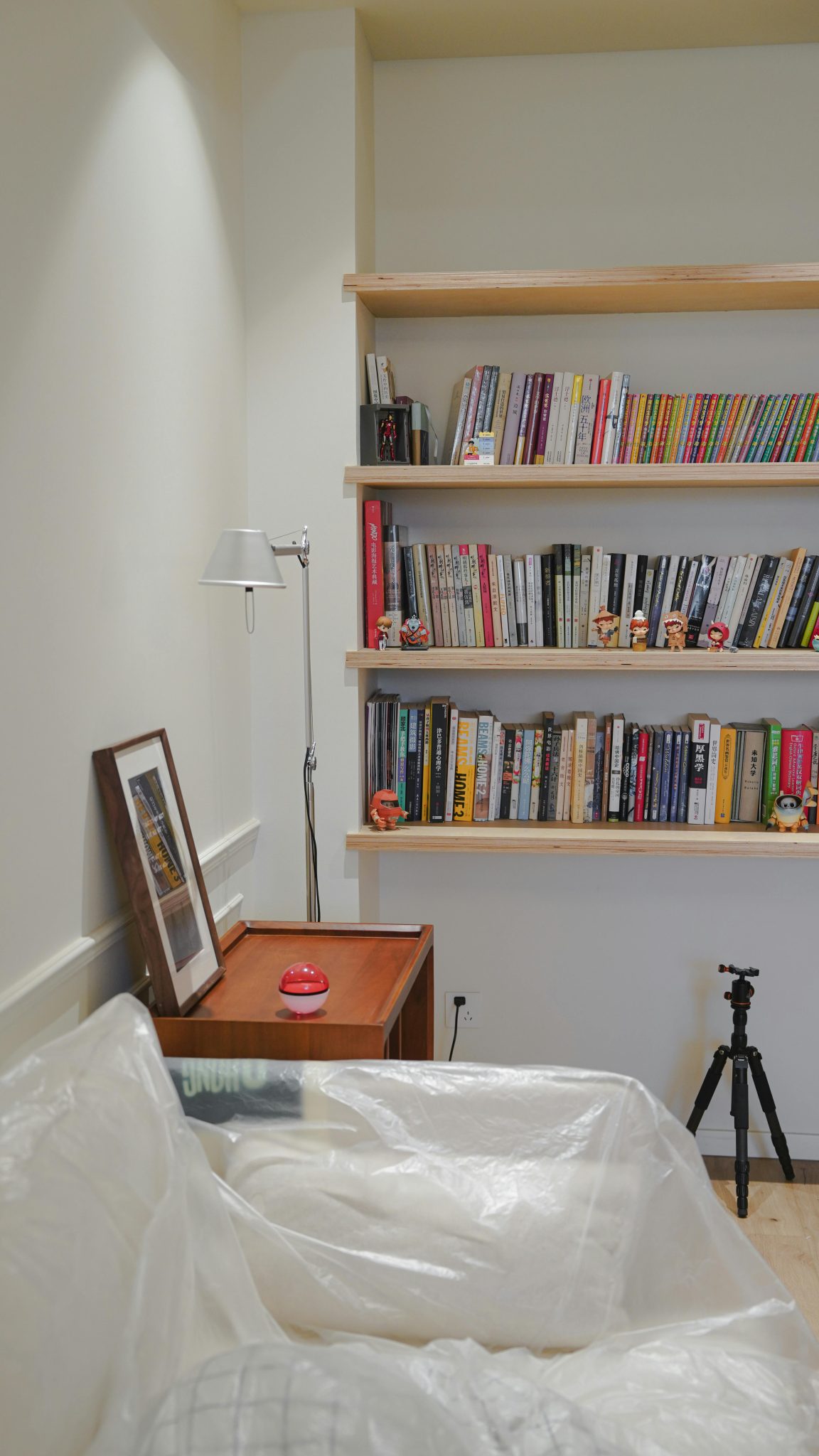 A tranquil reading space featuring wooden shelves filled with books, perfect for relaxation.