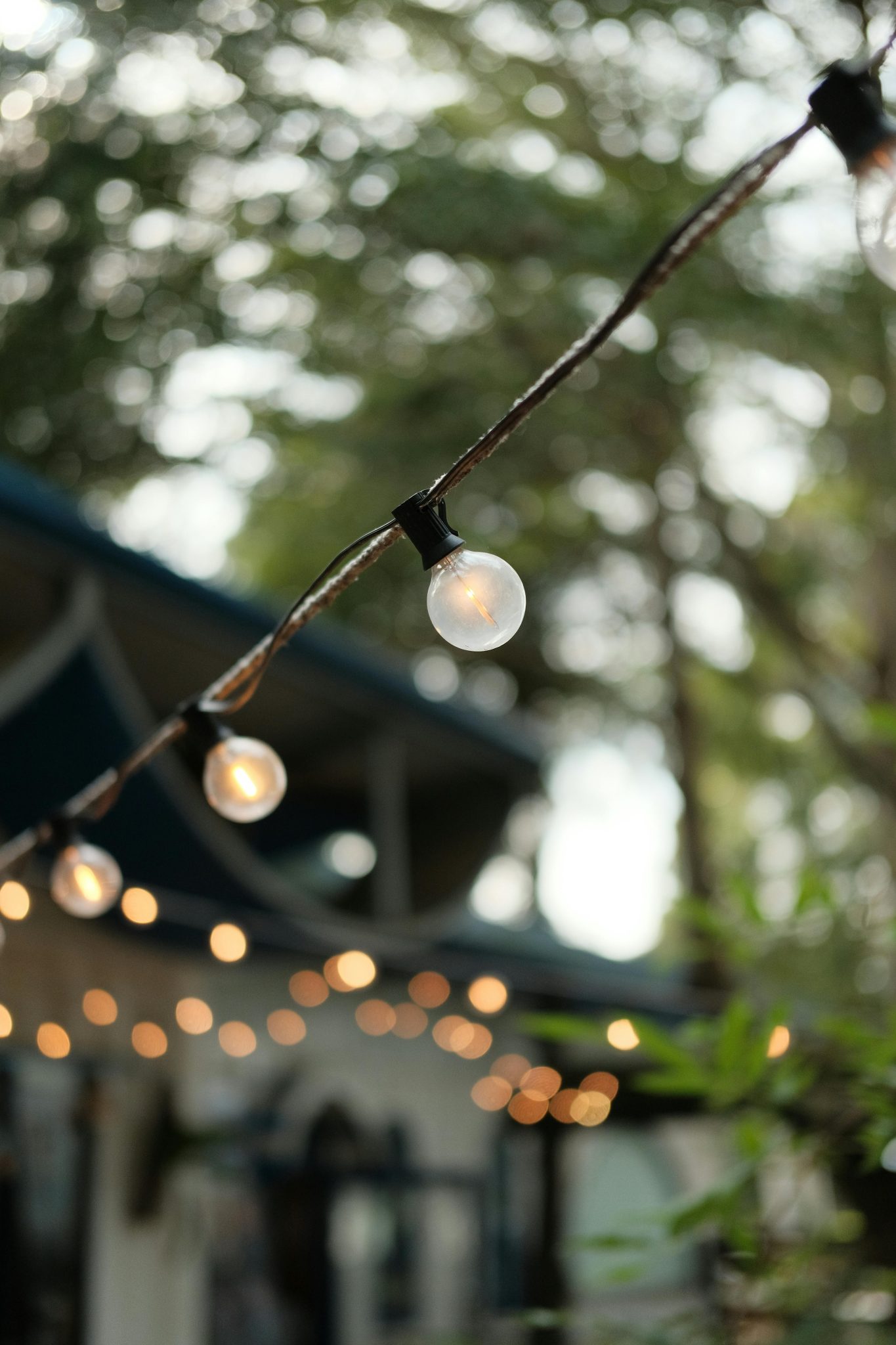 Beautiful outdoor string lights creating a warm ambiance in an evening garden setting.