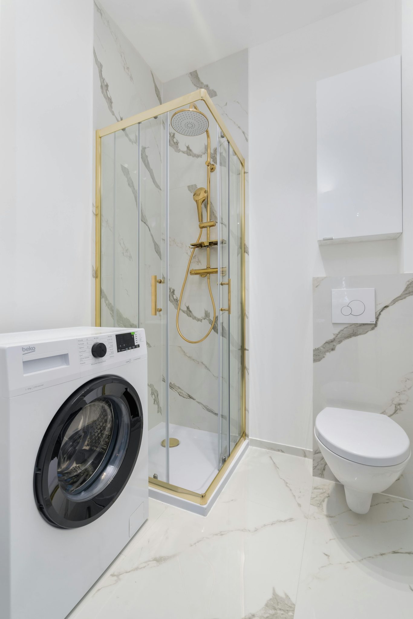 Bright and elegant bathroom featuring a luxury shower, toilet, and washing machine.