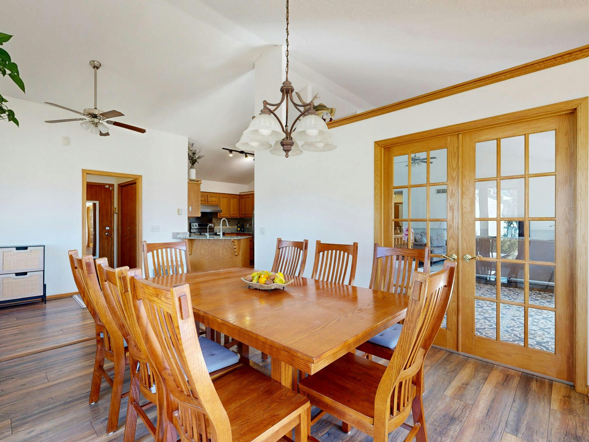 Bright dining area with wooden table, chairs, and modern decor.