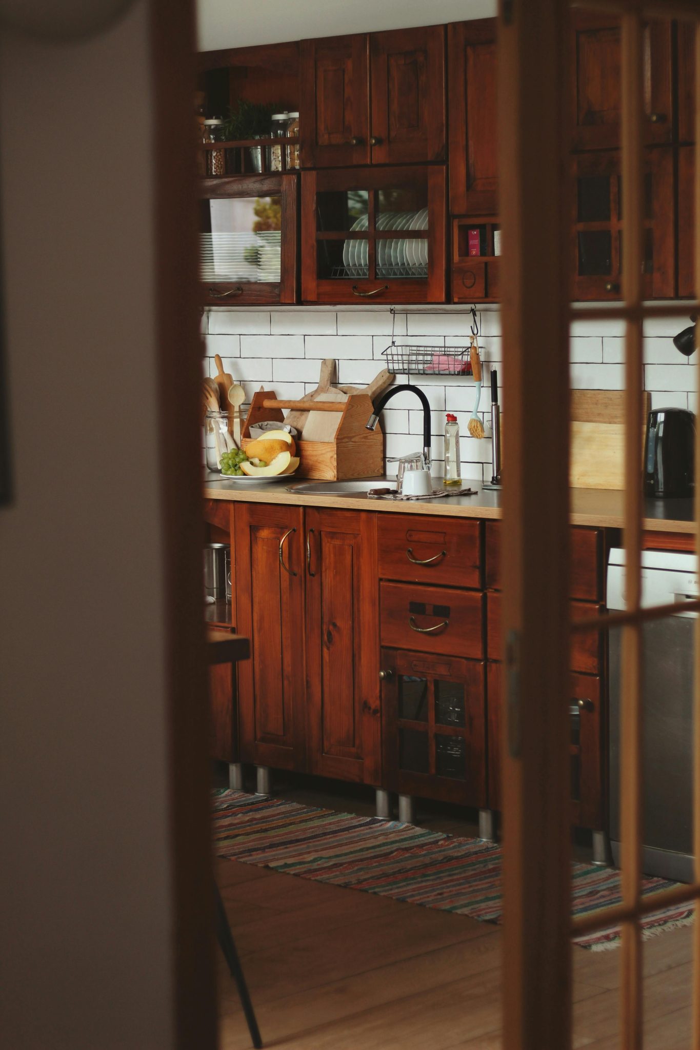 Capture of a cozy rustic kitchen with wooden cabinets and countertops, featuring warm tones and natural elements.