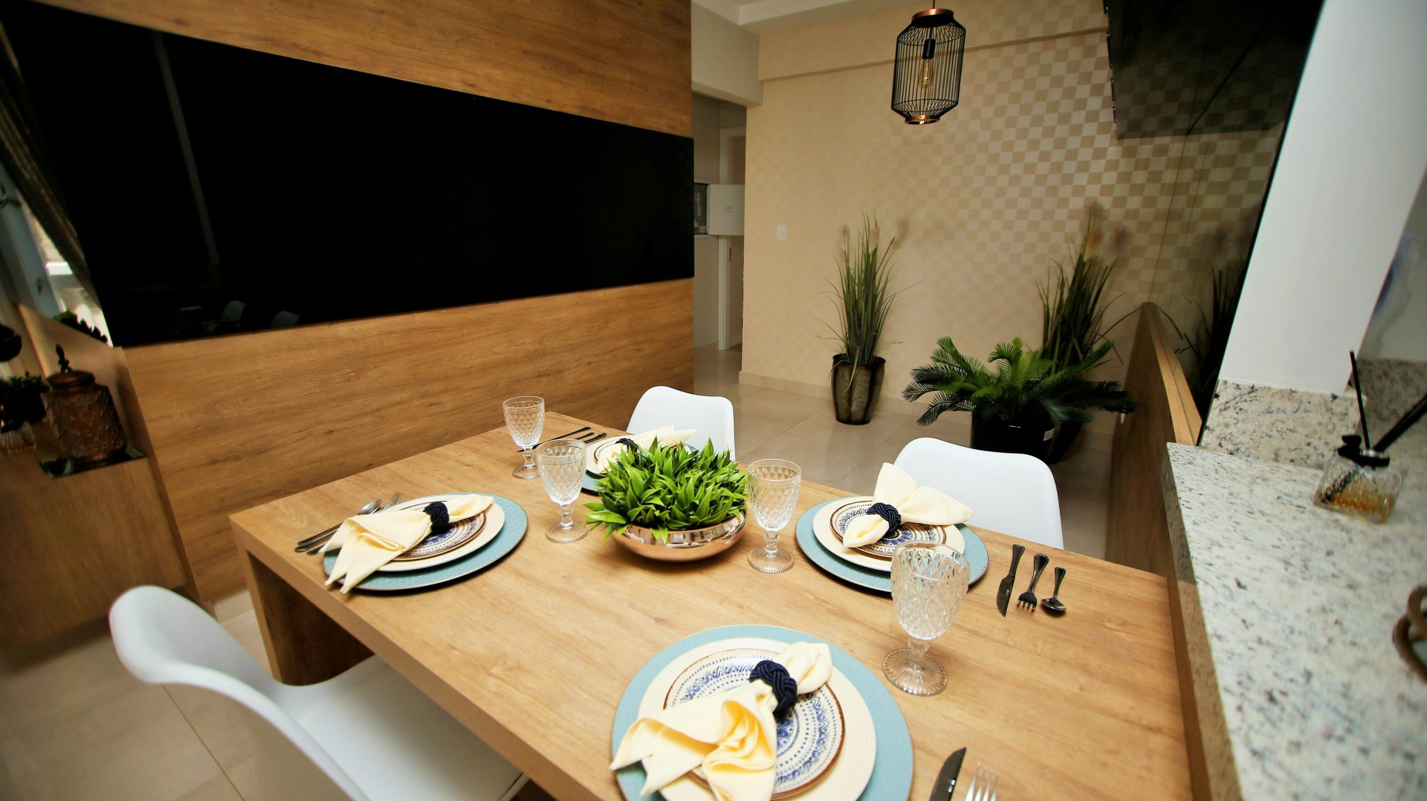 Contemporary dining area featuring a stylish wooden table set with elegant crockery and glassware.