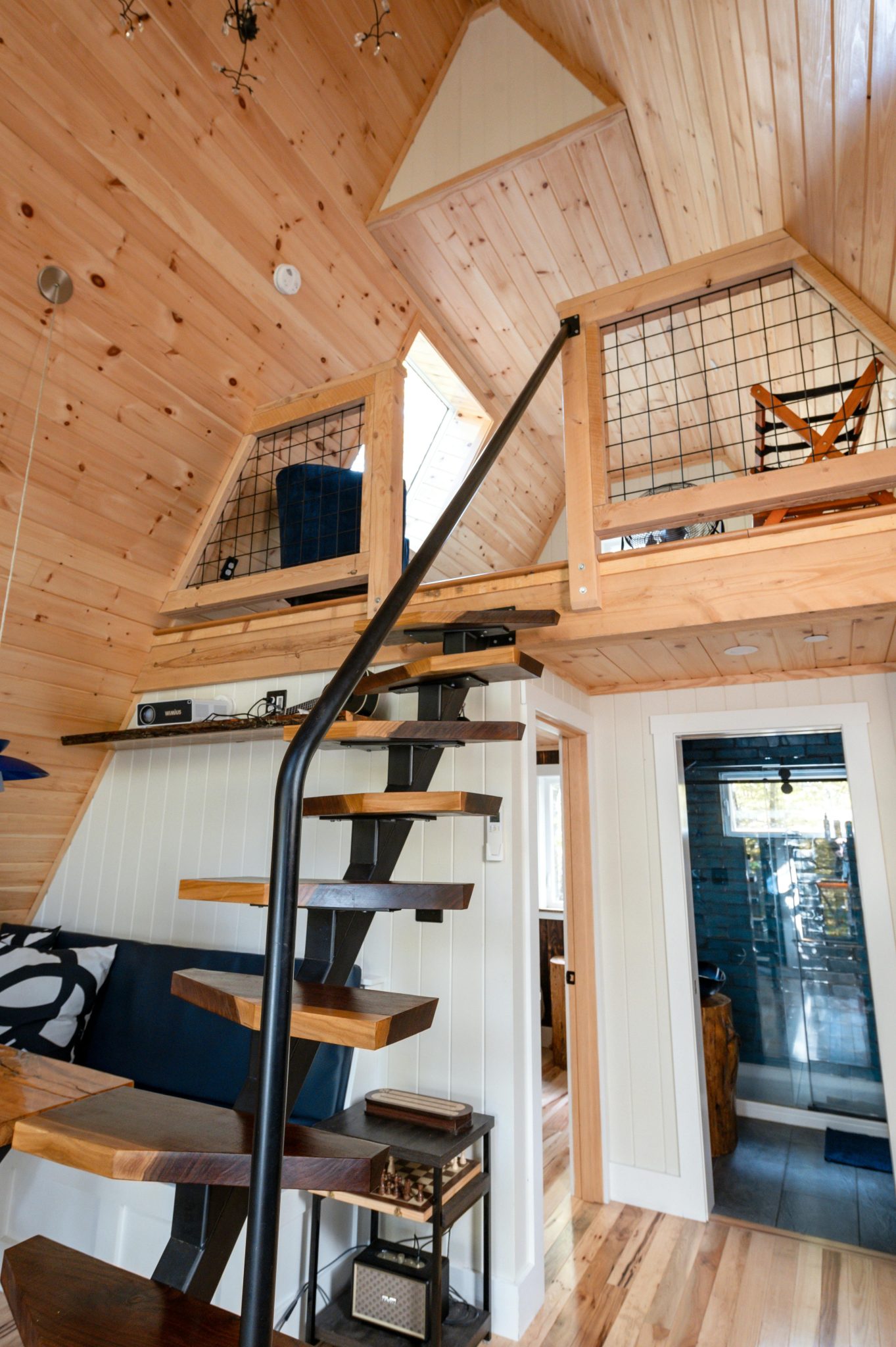 Discover a warm, rustic loft interior featuring wooden elements and modern design in a cozy cabin setting.