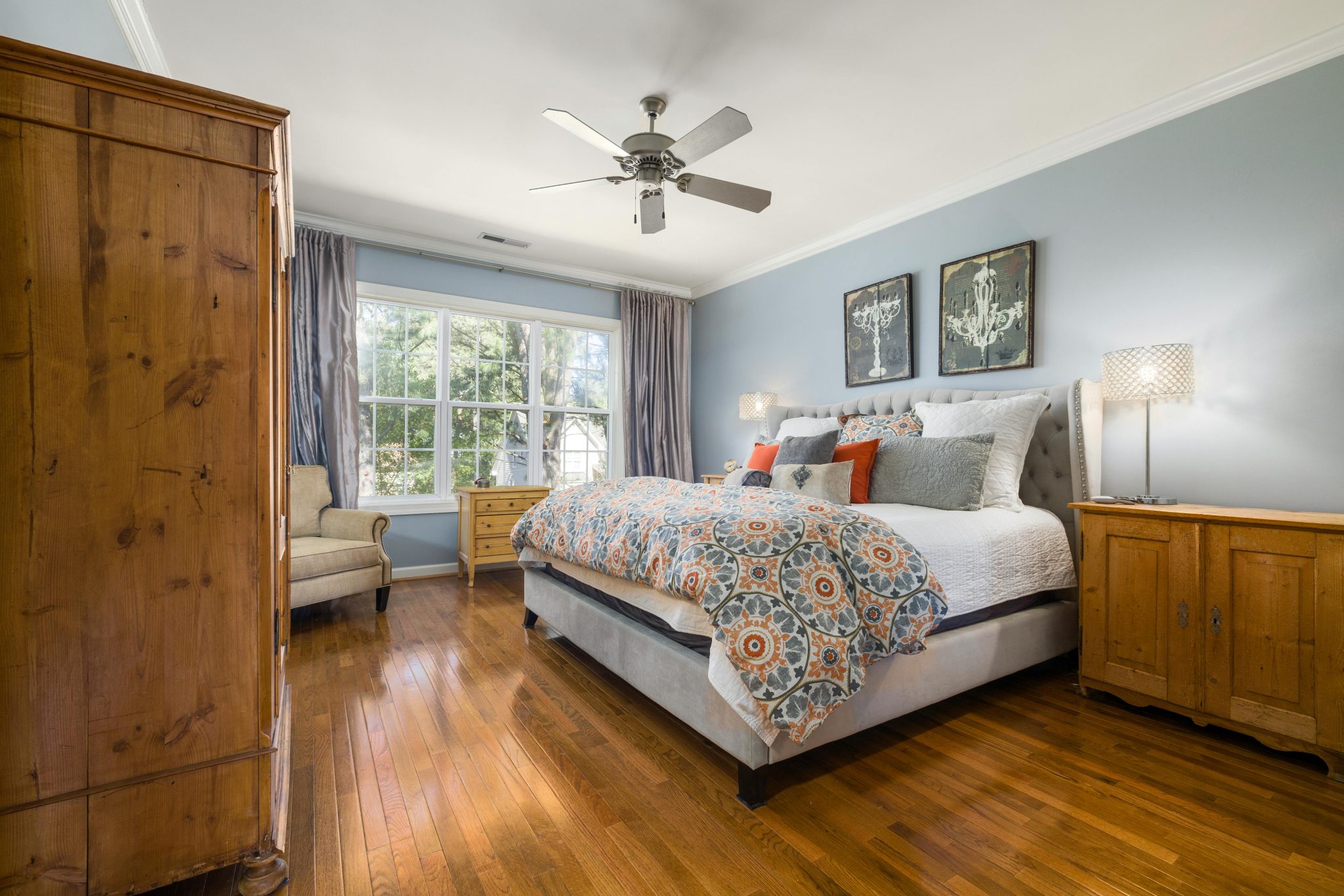 Elegant bedroom interior with wooden furniture and vibrant decor for a serene home atmosphere.