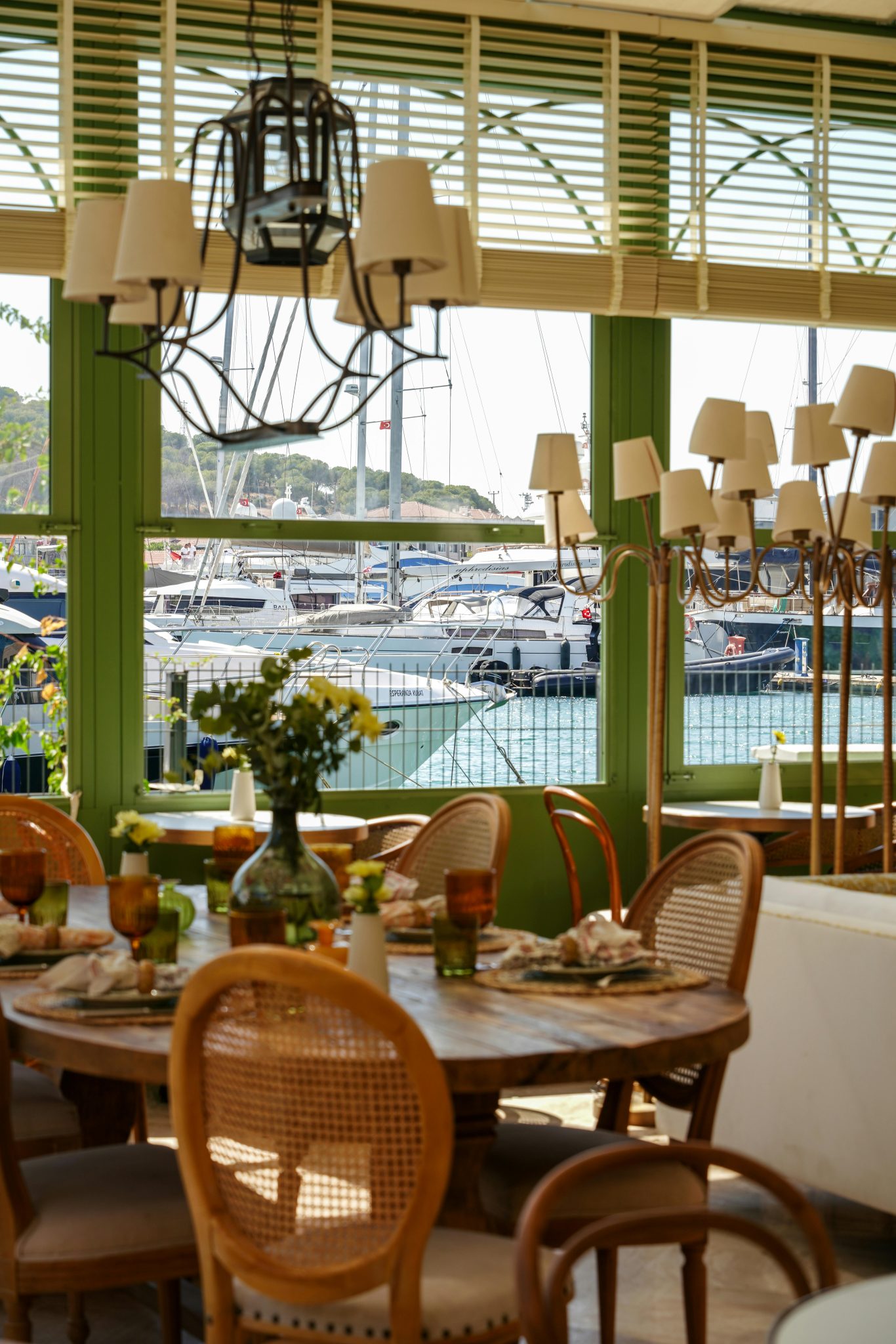 Elegant dining area with marina views, featuring rustic decor and natural lighting.
