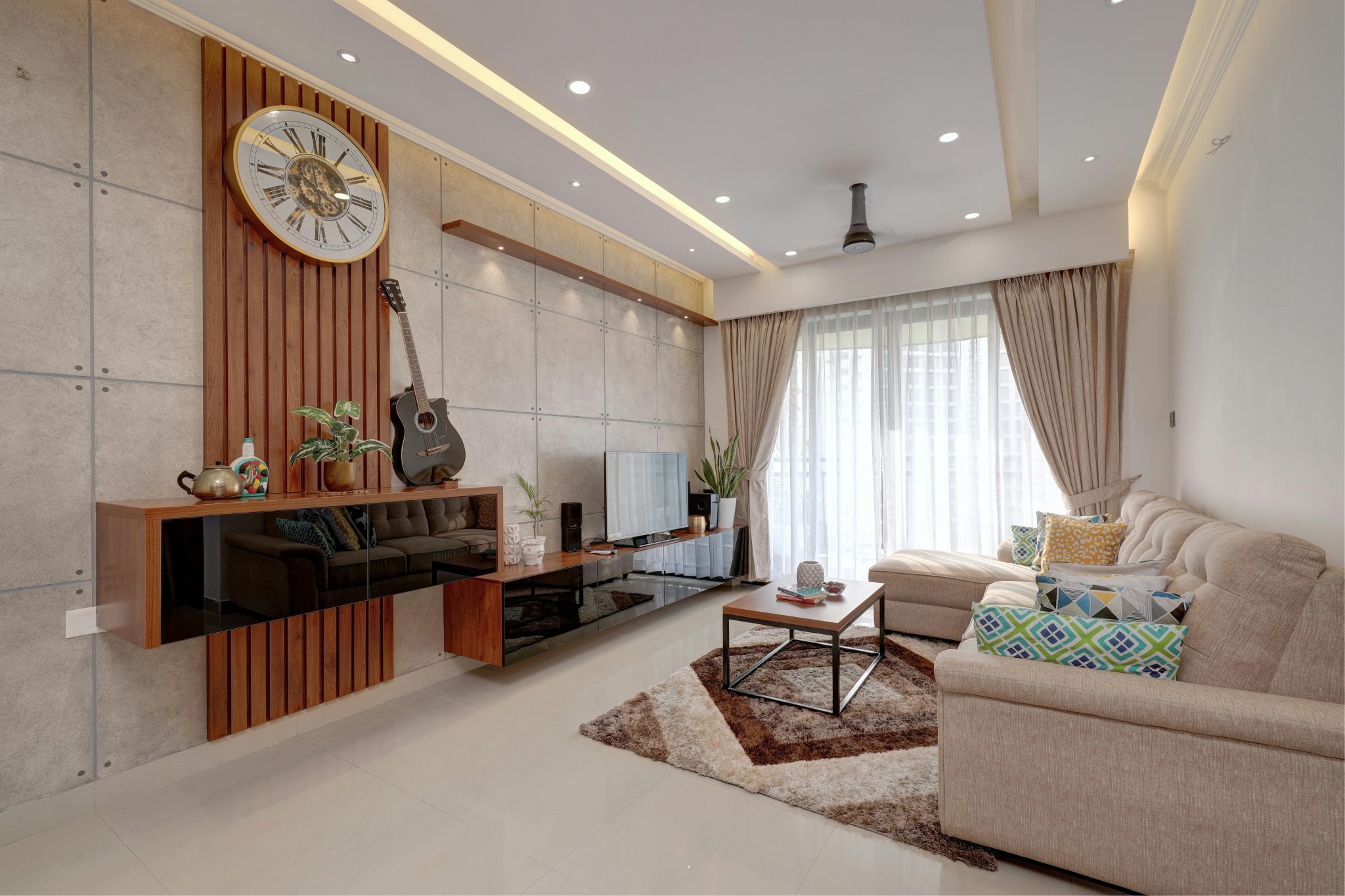 Elegant living room in Kochi, India with modern decor and warm tones.