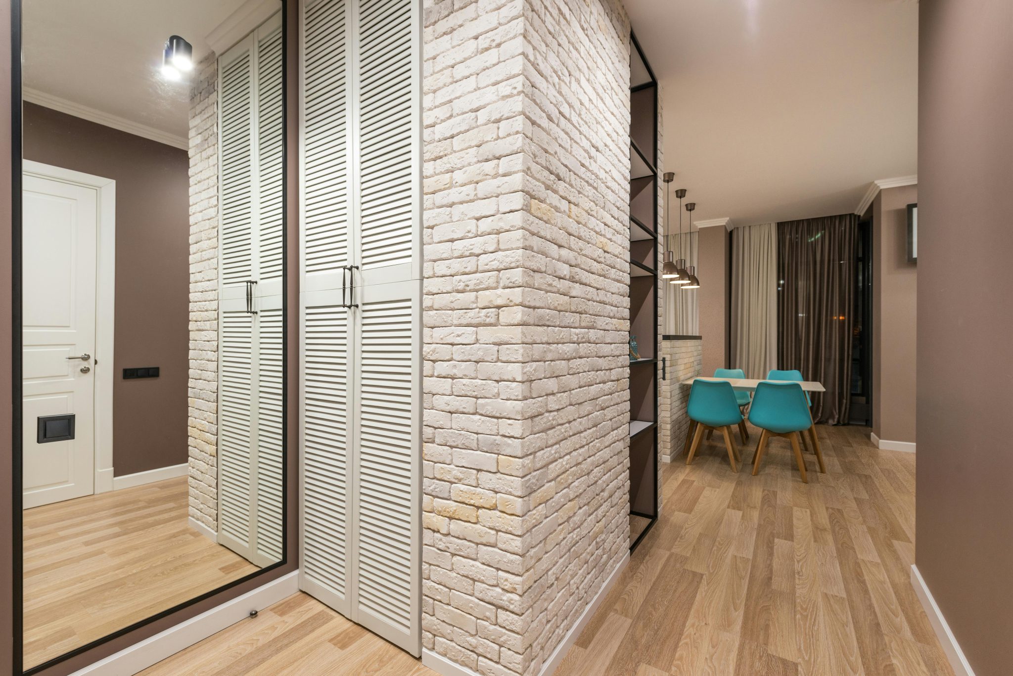 Interior design of modern corridor with whole wall mirror and built in wardrobe and laminated floor