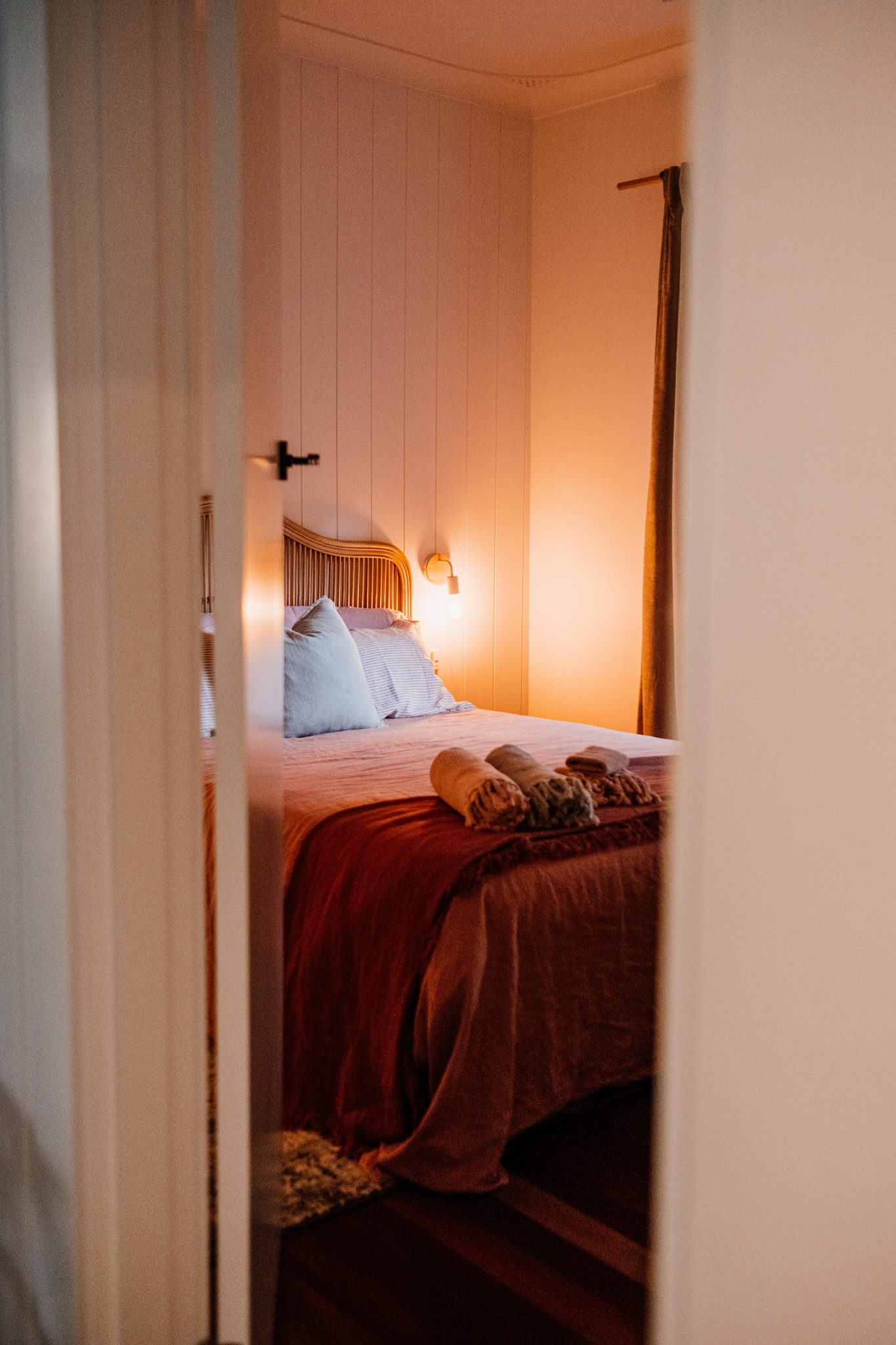 Inviting bedroom with soft ambient lighting and warm decor for a peaceful atmosphere.