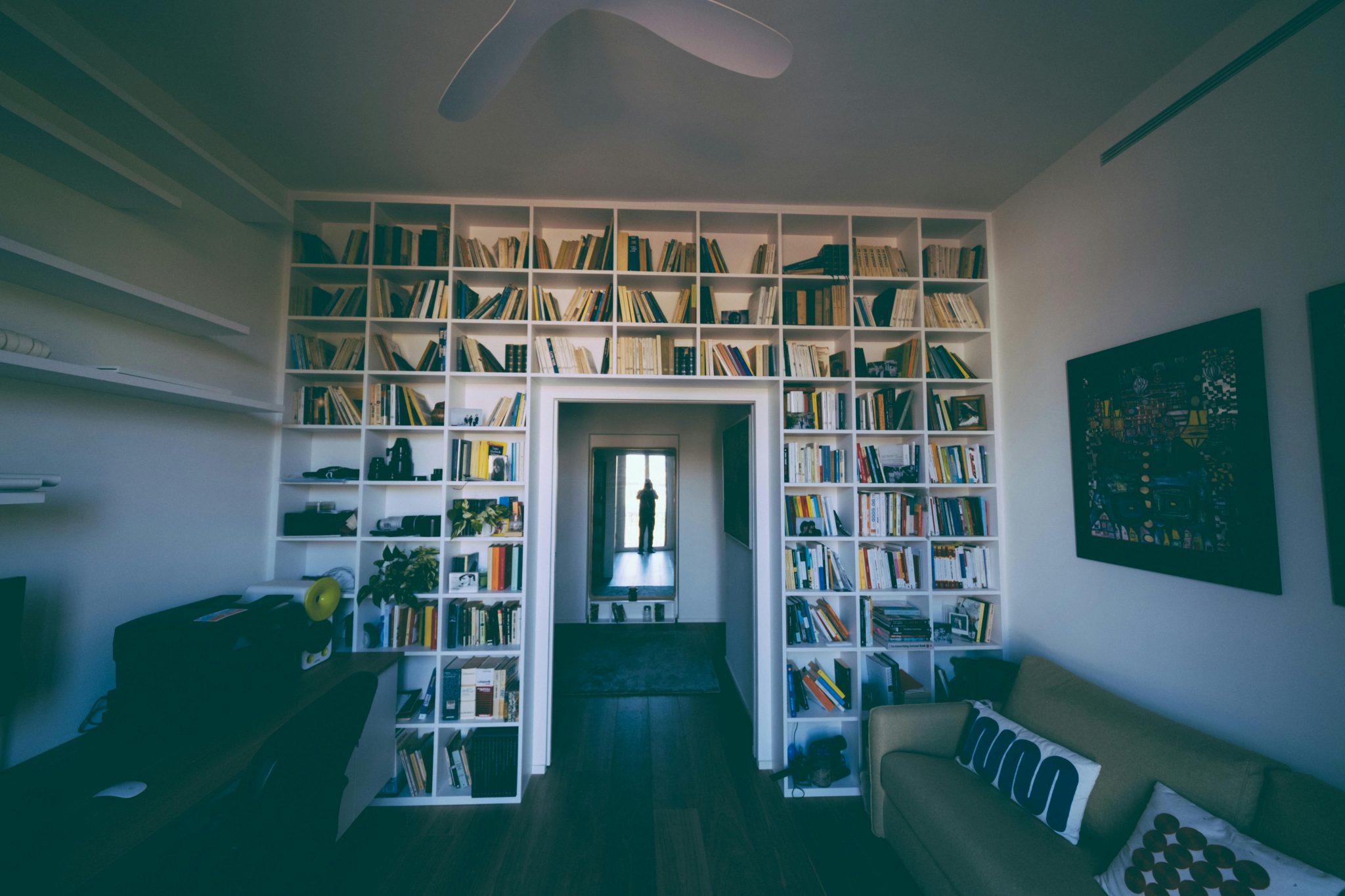 Inviting home library featuring tall bookshelves and cozy seating, perfect for relaxation and reading.