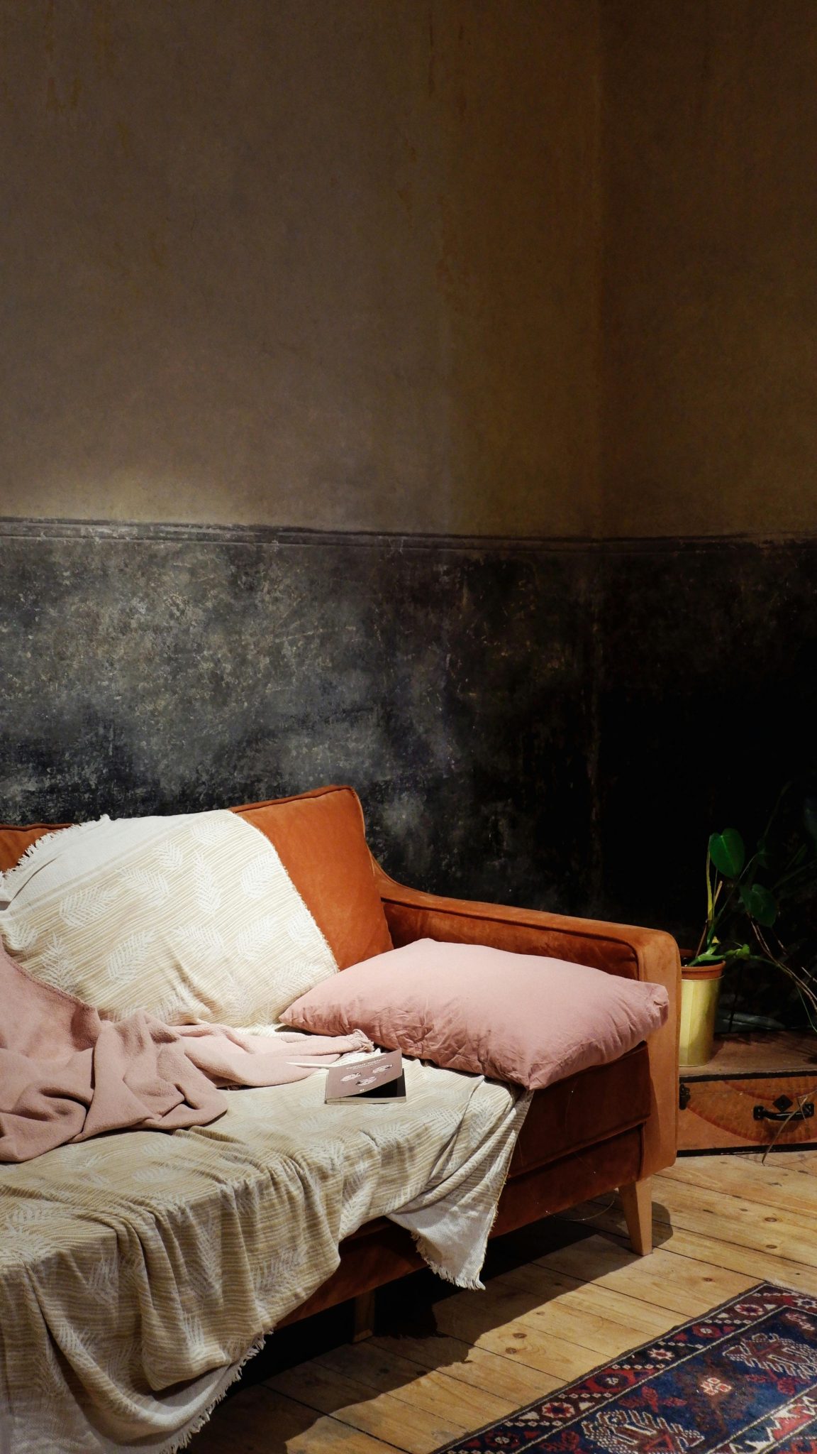 Inviting living room featuring a comfy sofa, cozy blankets, and a warm ambiance.
