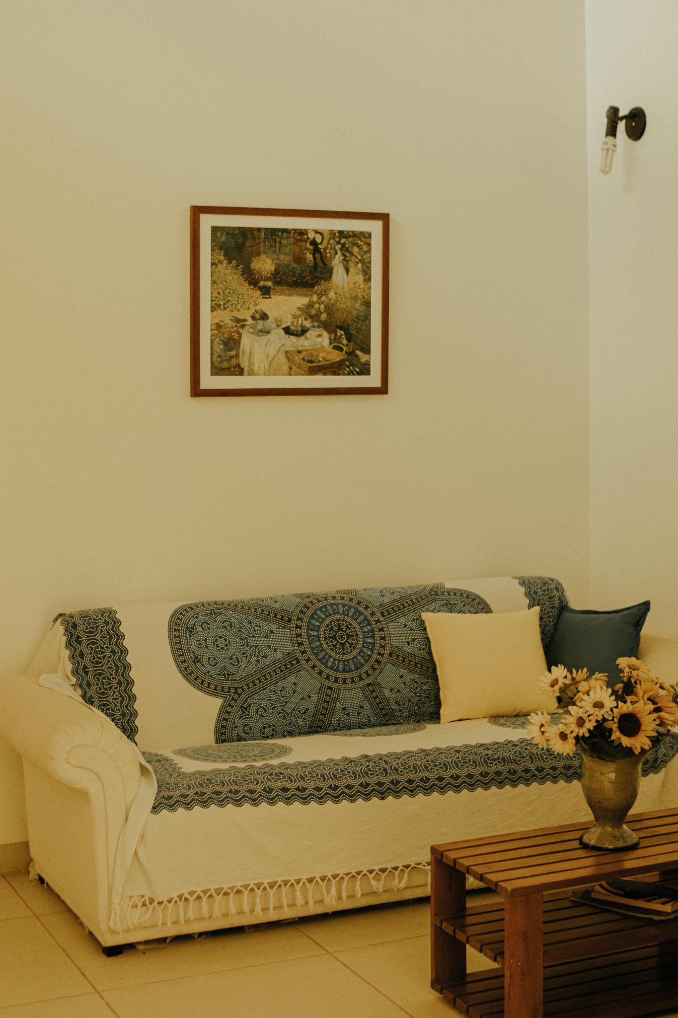 Inviting living room featuring a patterned sofa, framed artwork, and floral centerpiece.