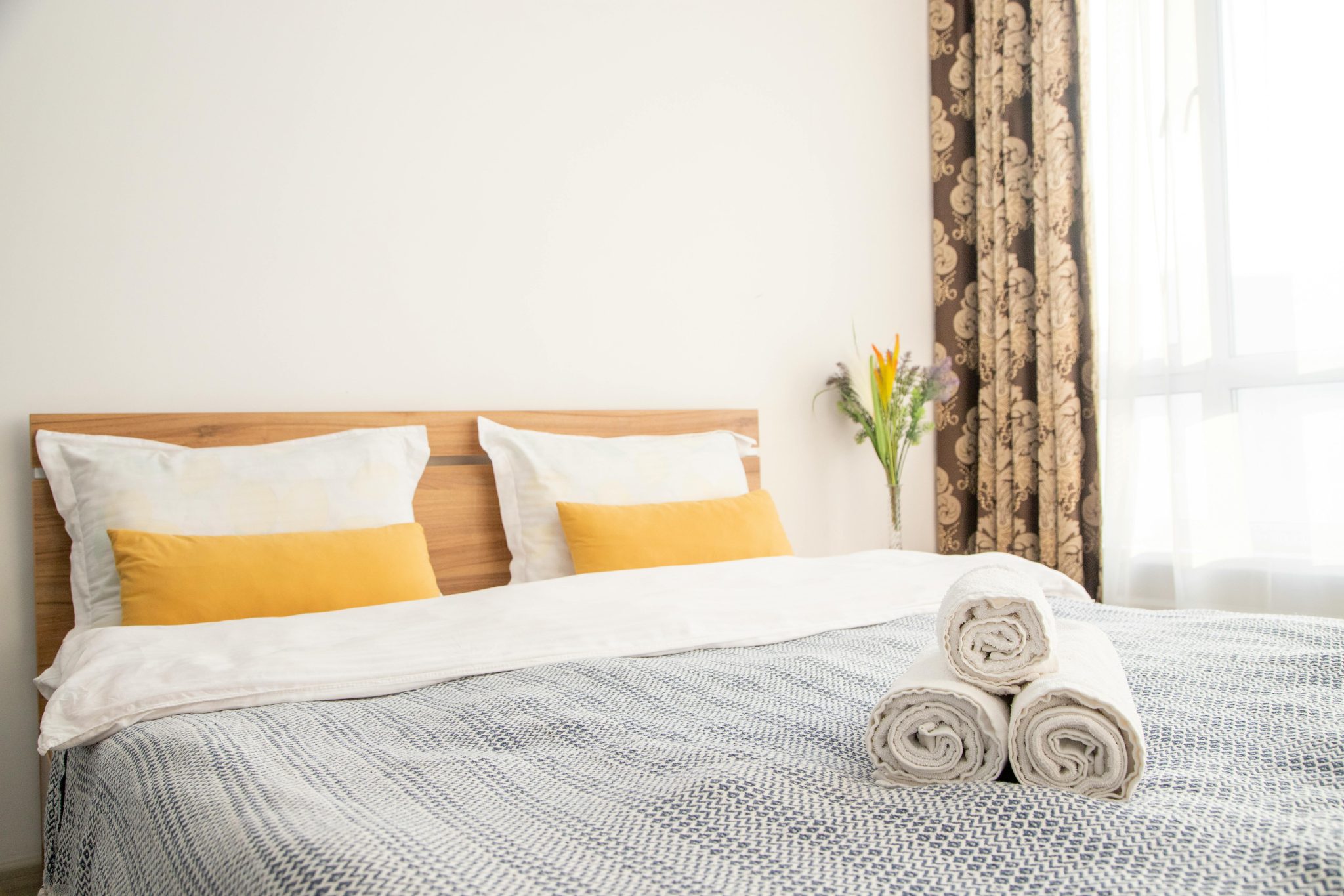 Inviting modern bedroom with plush beddings and elegant decor, perfect for relaxation.