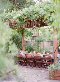 Lush Backyard Pergola With Wisteria Over Outdoor Dining Table' by Stocksy Contributor 'Lexia Frank' - Stocksy