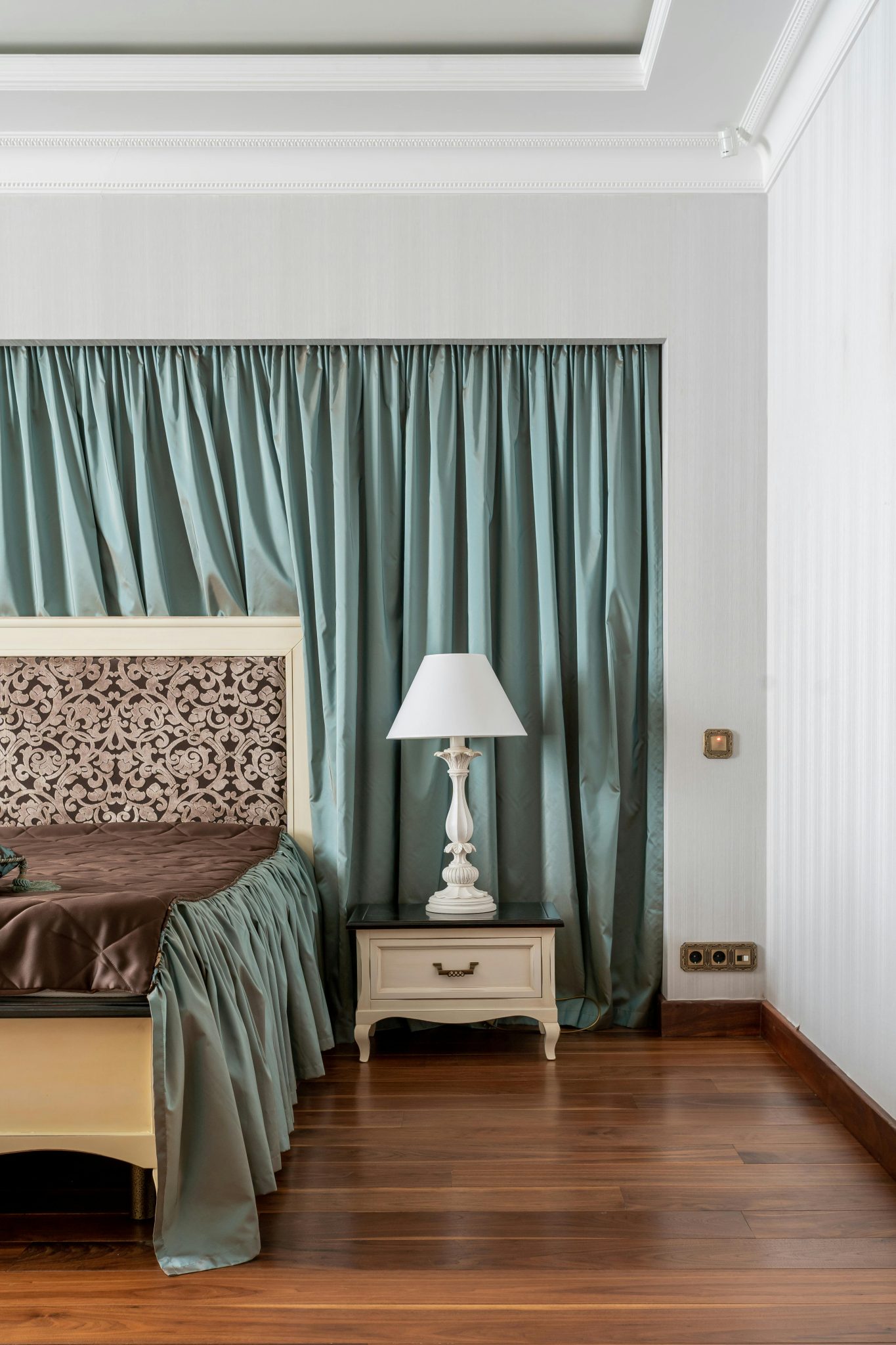 Luxurious bedroom showcasing elegant decor with a classic touch, featuring a wooden floor.