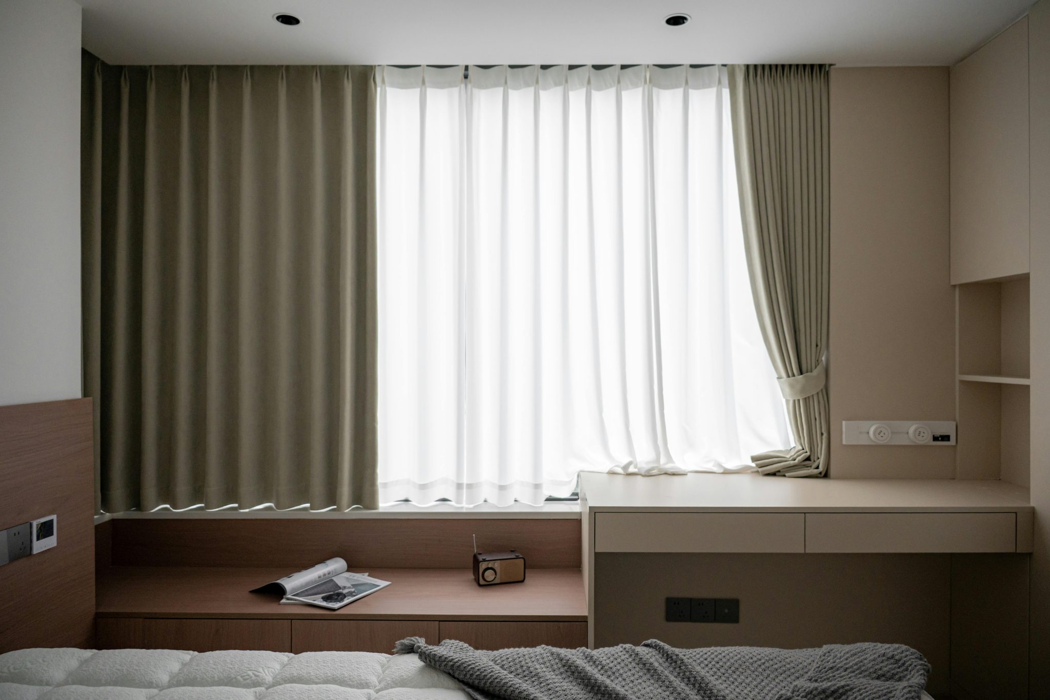 Minimalist modern bedroom with cozy decor, natural light, and stylish furnishings.
