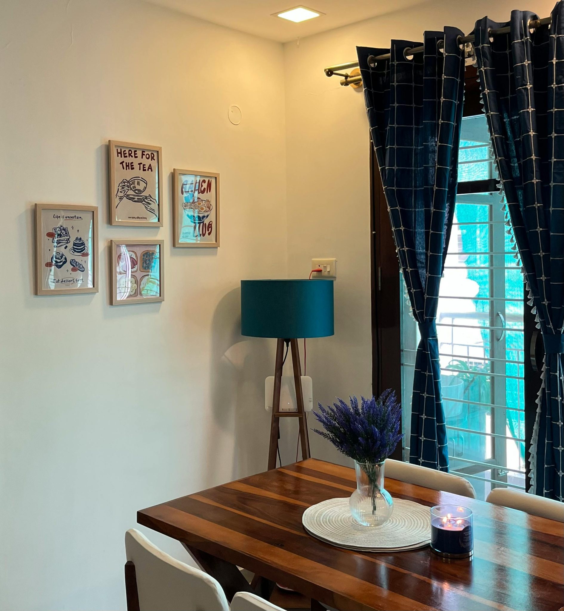 Modern dining area featuring stylish decor, artwork, and natural lighting.
