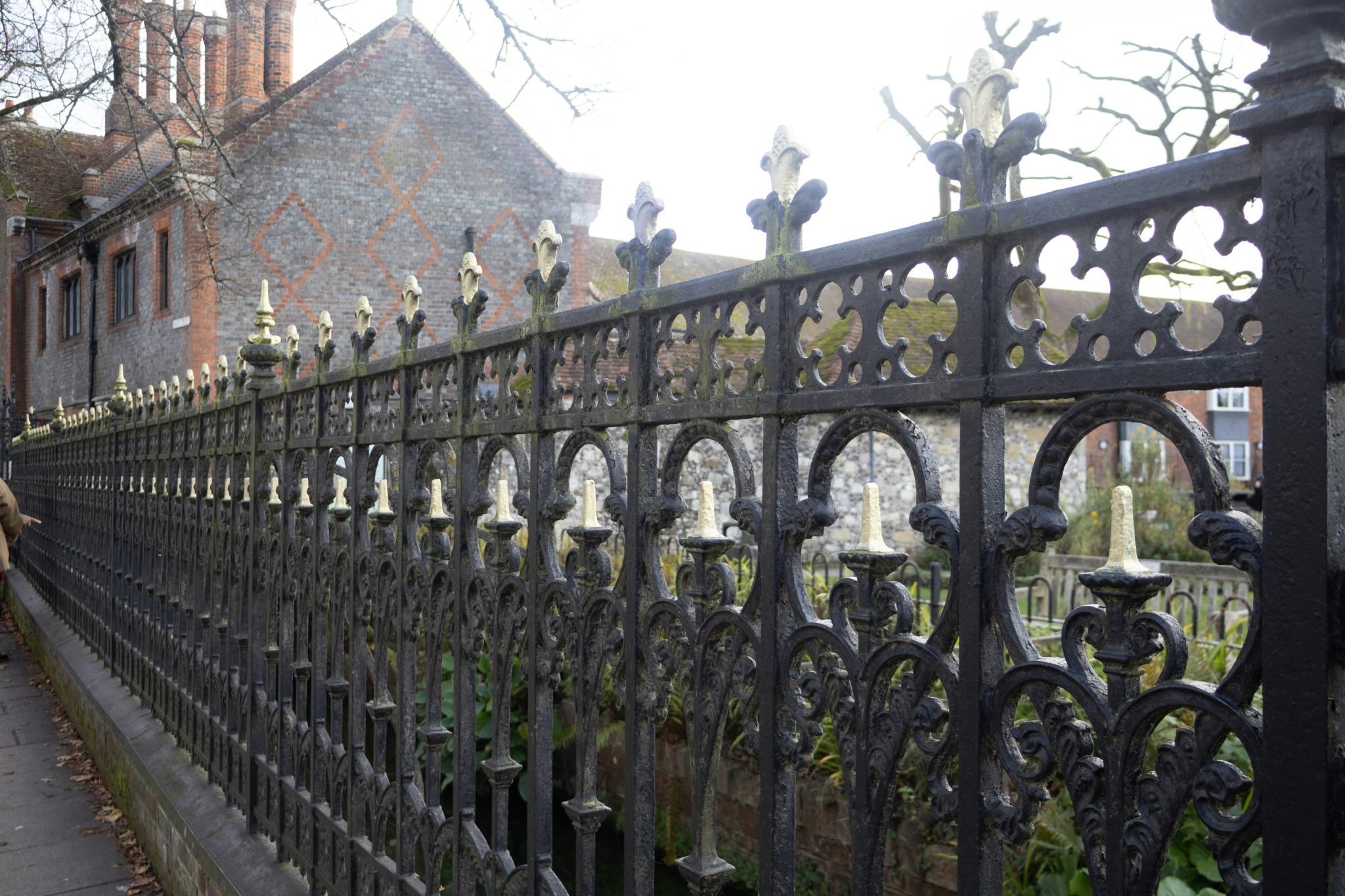 Ornate black metal fence with decorative gold accents