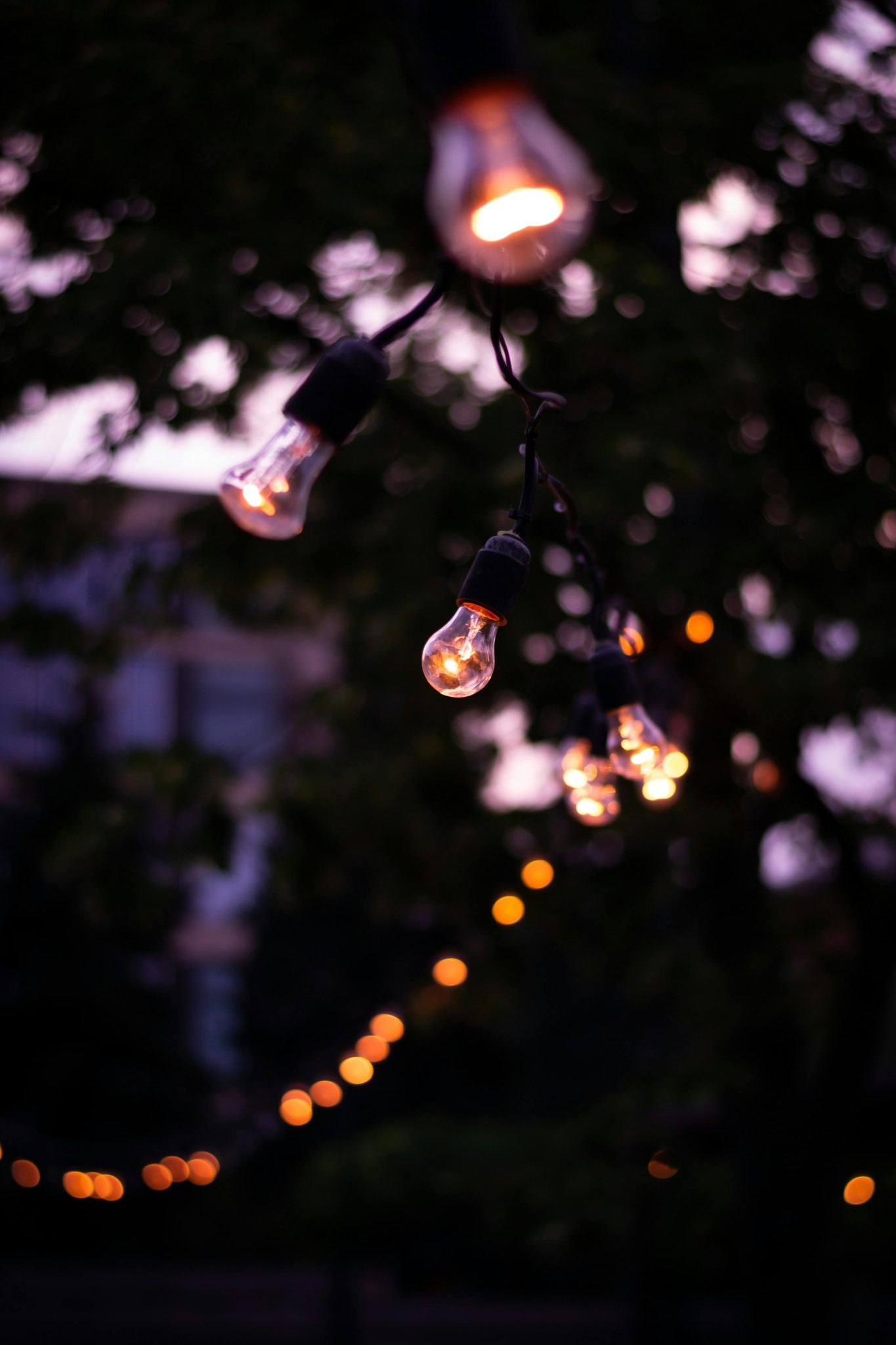 Outdoor string lights casting warm glow in Kharkiv, creating a serene and cozy atmosphere.