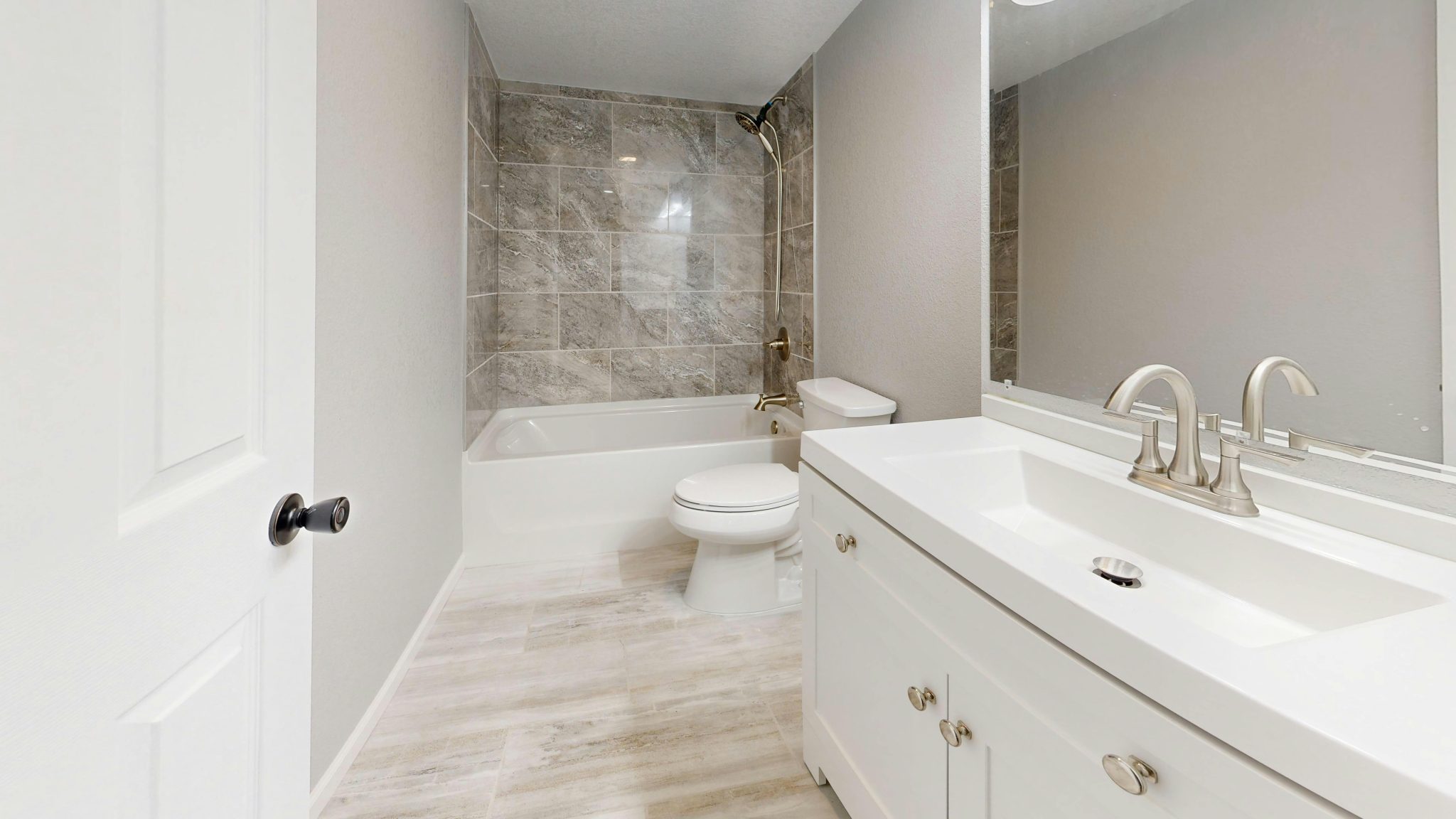 Sleek minimalist bathroom featuring modern fixtures and neutral tones for a contemporary look.