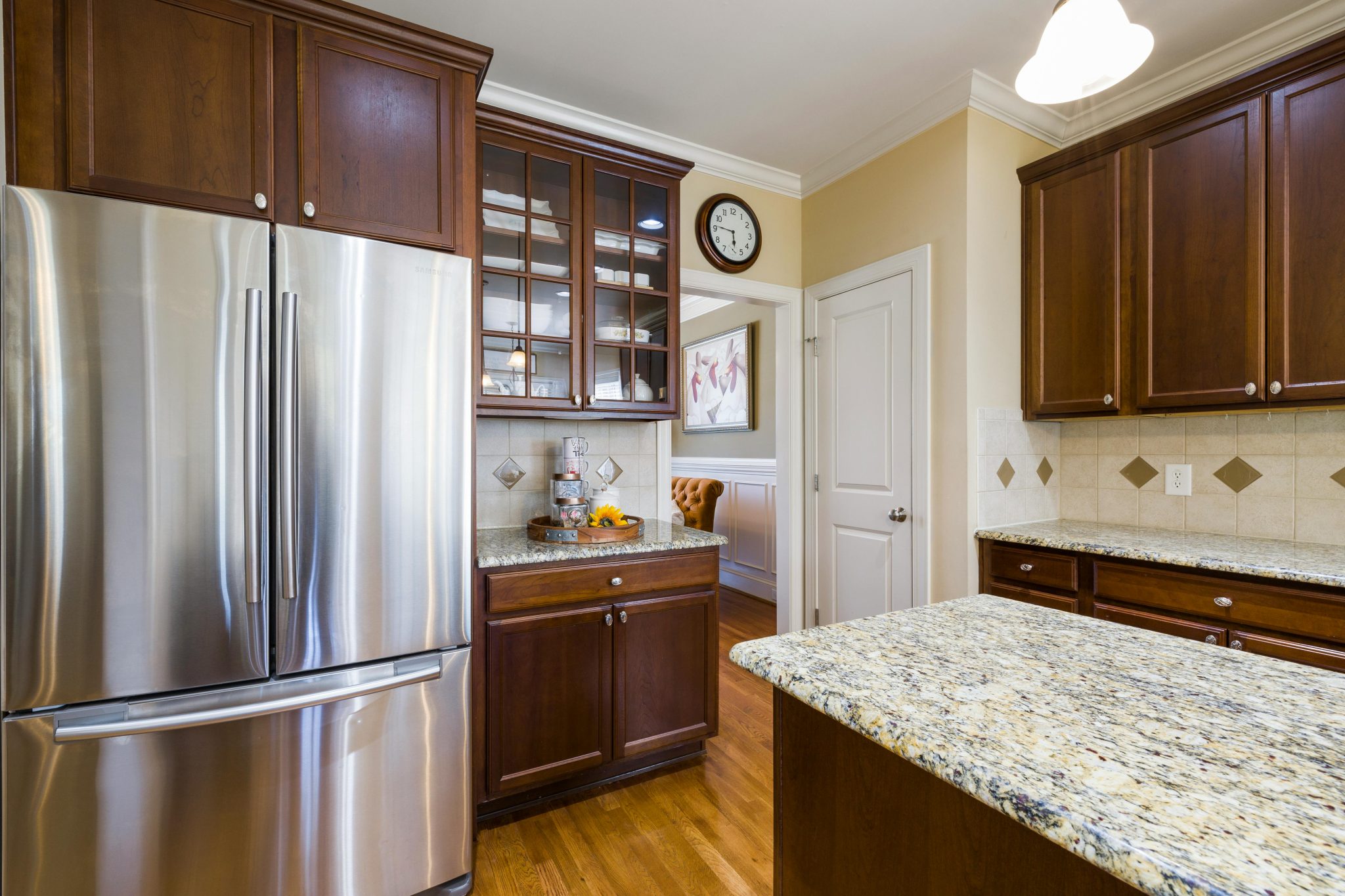 Spacious kitchen featuring stainless steel appliances and elegant wood cabinetry with granite countertops.