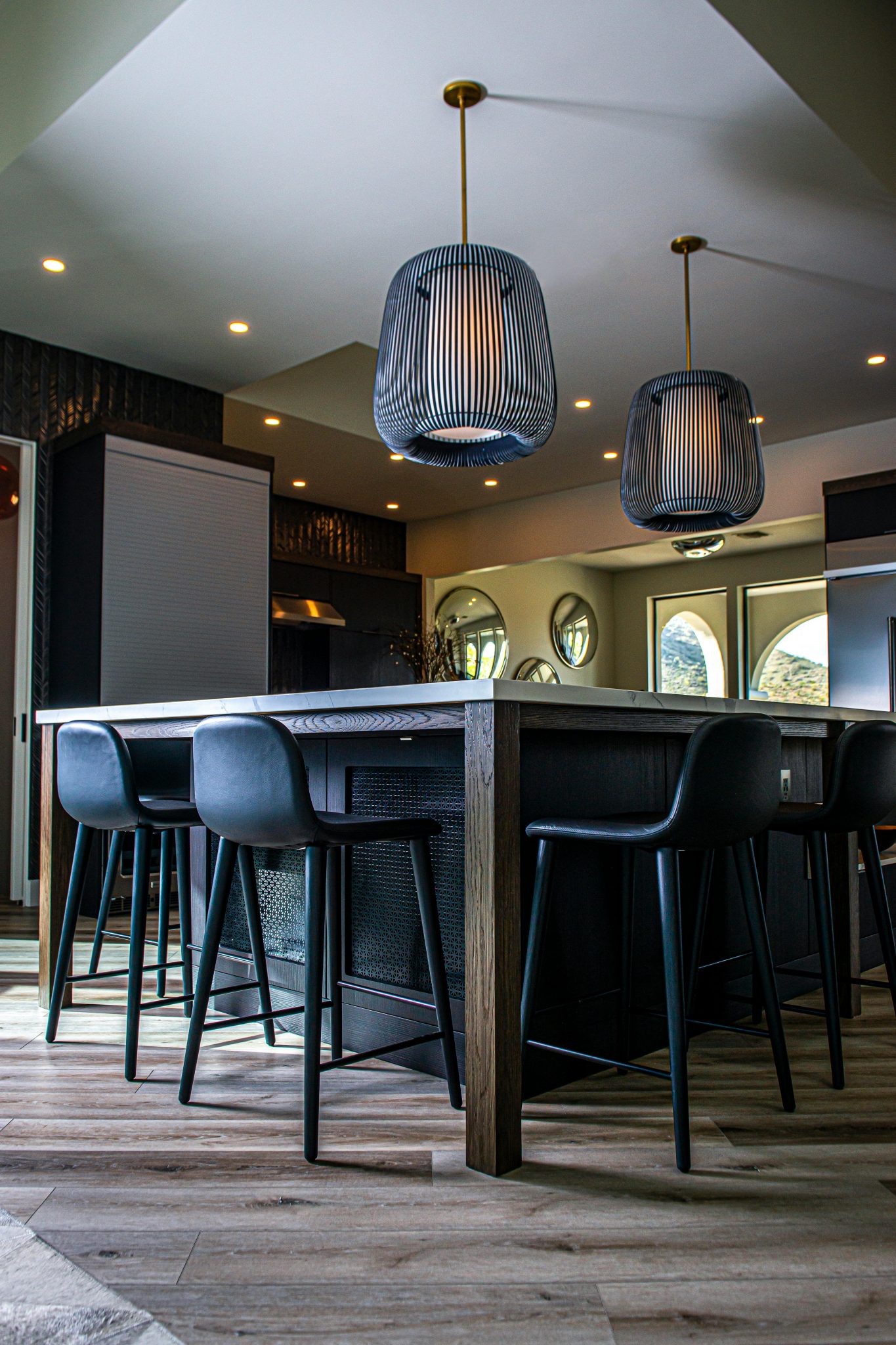 Stylish kitchen interior featuring pendant lighting above a central island.