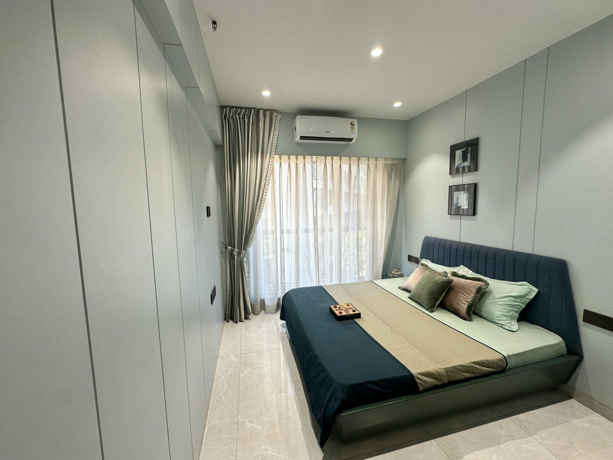 Stylish minimalist bedroom with natural light and modern decor.
