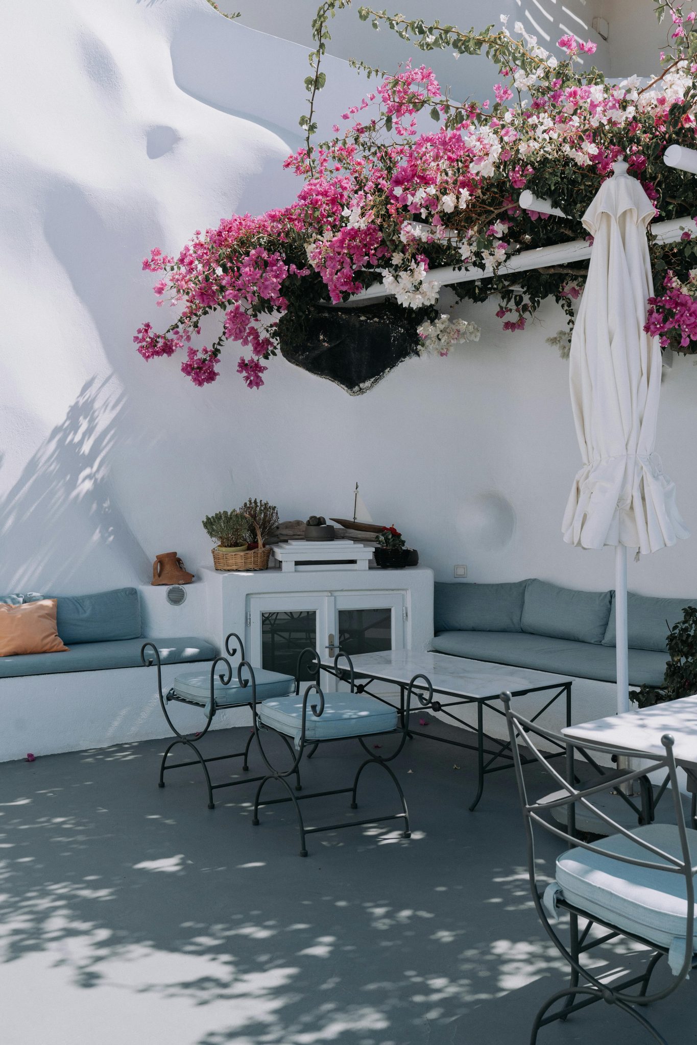 Stylish outdoor patio featuring blooming bougainvillea and elegant seating with a contemporary design.
