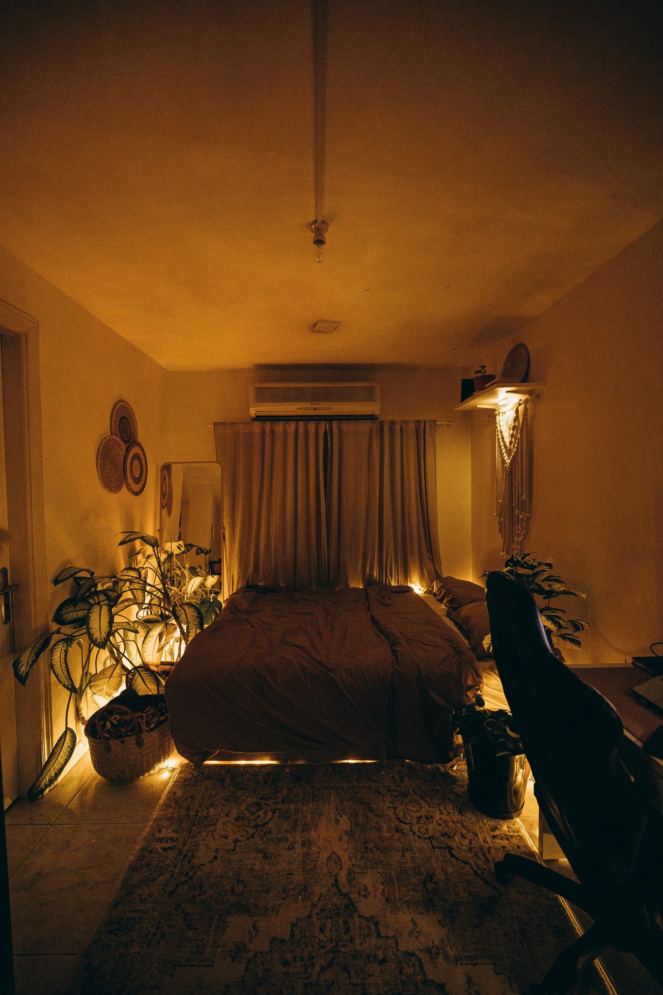 This serene bedroom showcases a warm ambiance with cozy lighting, perfect for relaxation and comfort.