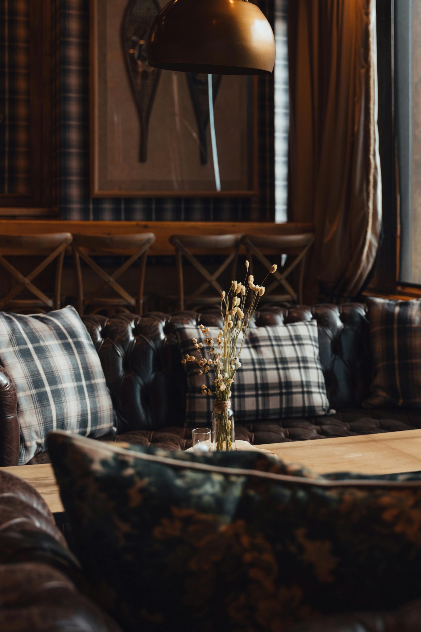 Warm and inviting living room with plaid pillows and rustic decor, perfect for cozy settings.