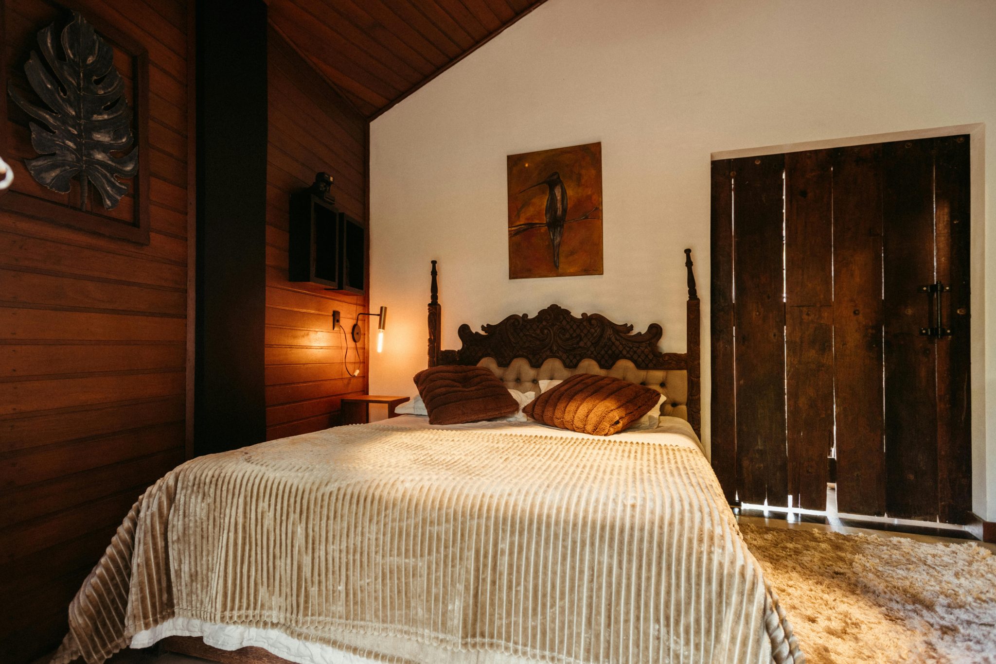 Warm, inviting wooden bedroom interior in Santa Teresa, Brasil.
