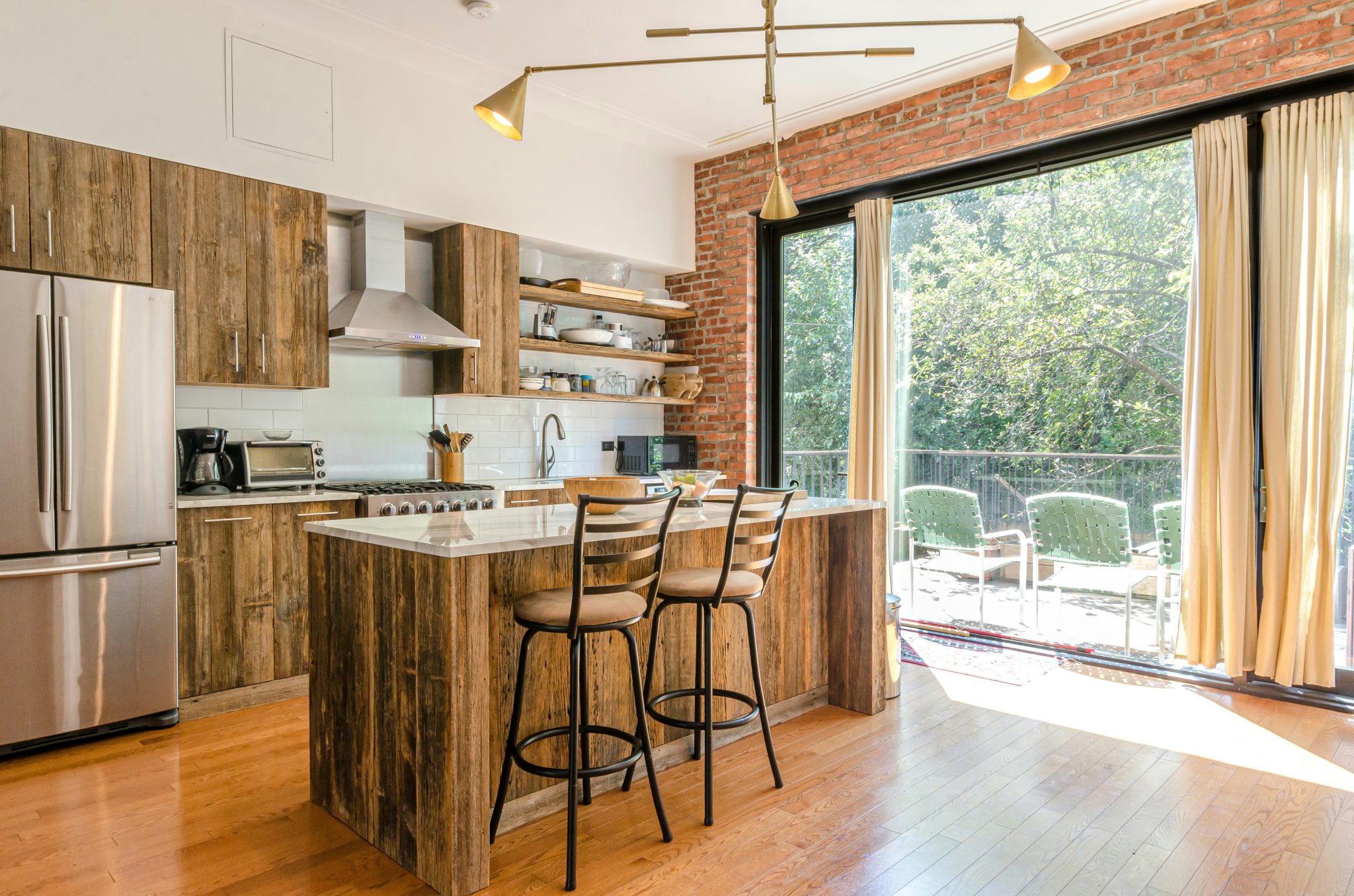 Wood kitchen cabinets. Brick wall. Floor to ceiling windows.Brooklyn NYC